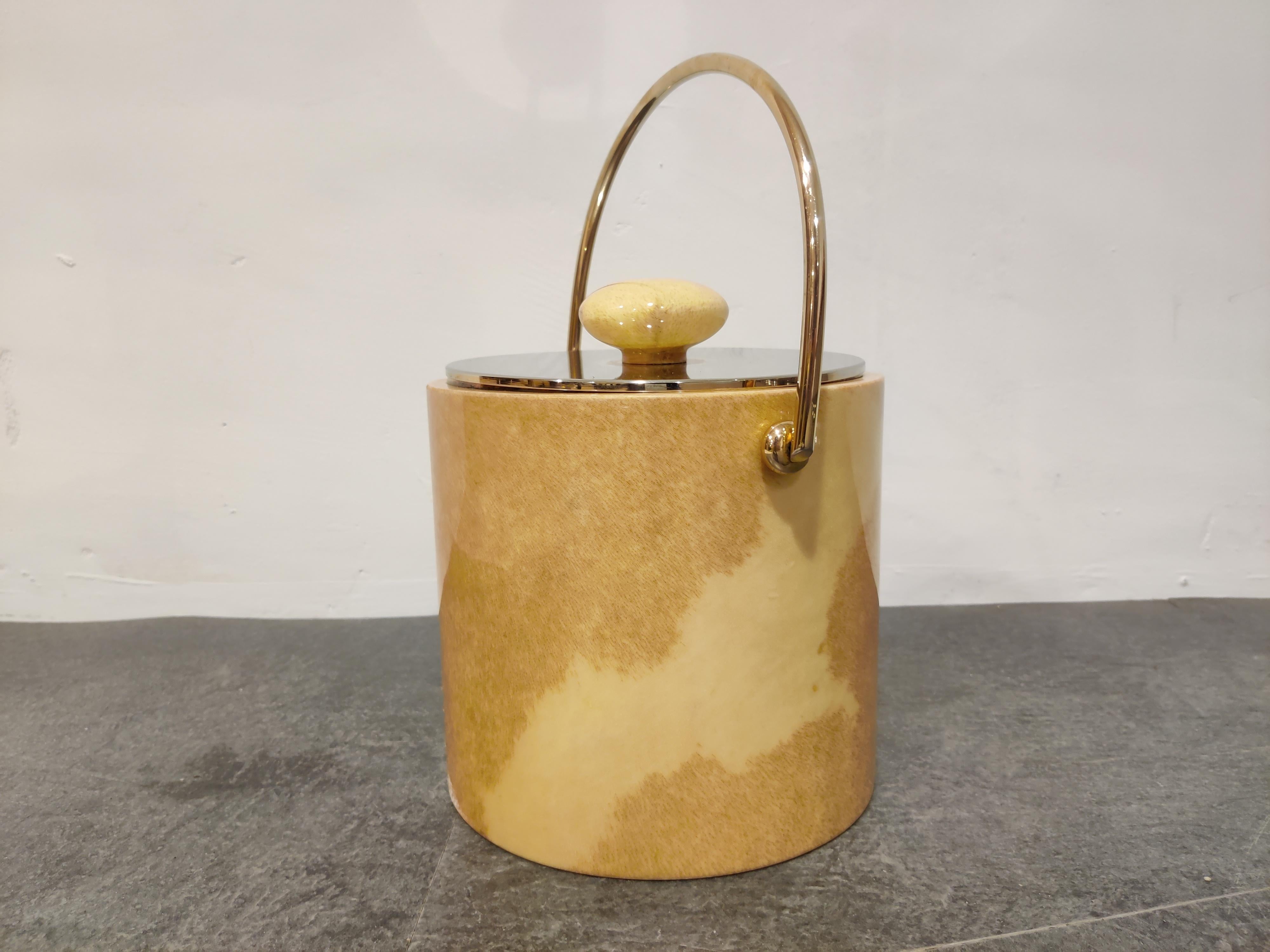 Midcentury ice bucket by Aldo Tura made from goatskin and brass handle.

Interesting piece with a great look.

Good, original condition.

Measures: Height 34cm/13.38