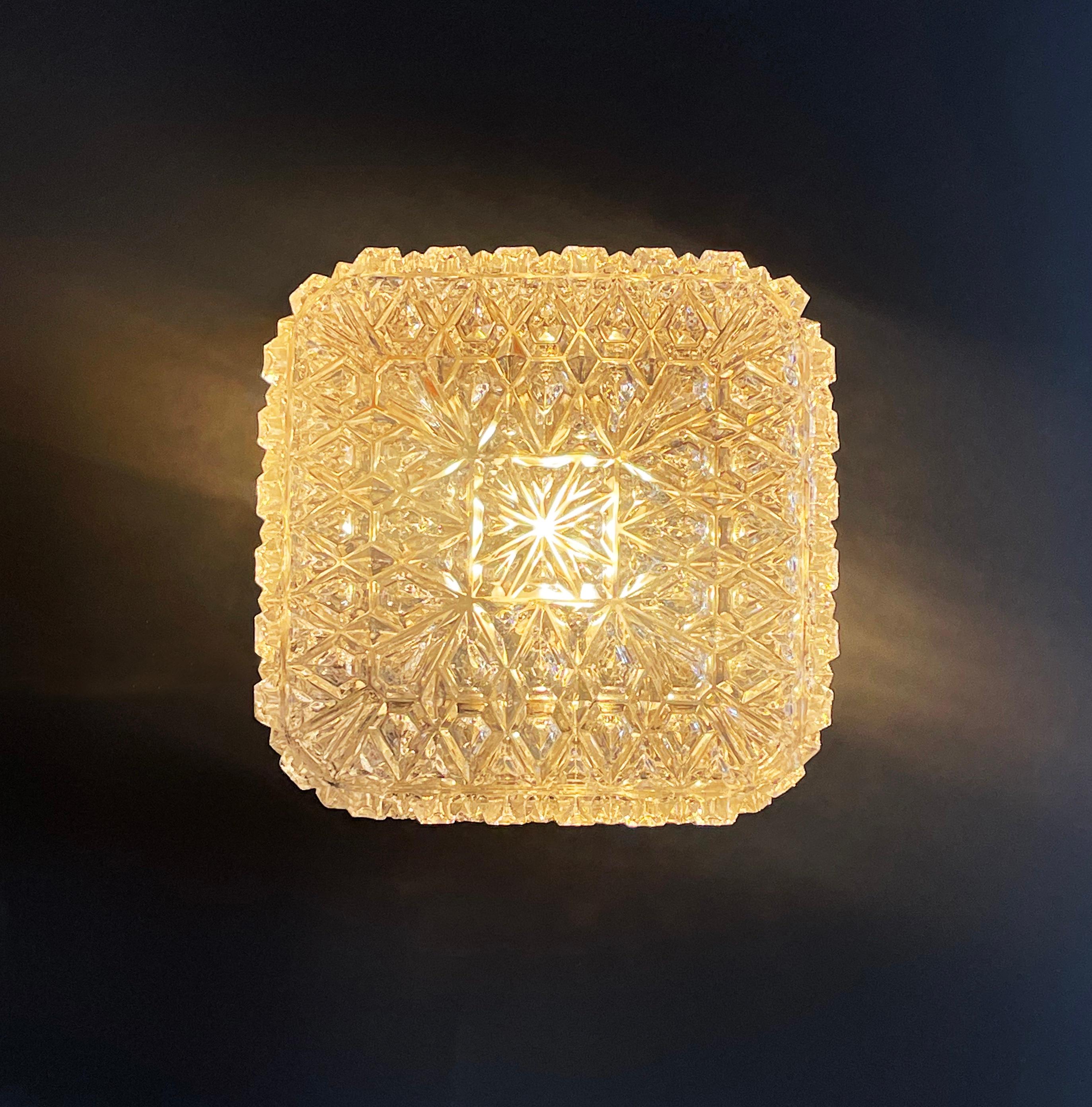 Magnificent flush base ceiling or wall lamp by ''Glashütte Limburg'', Germans famous mid century manufacturer of high-end design lighting.
Comes in a rocky ice crystal like square shape in 2 subtle levels on the top. 
The lampshade consists of ice