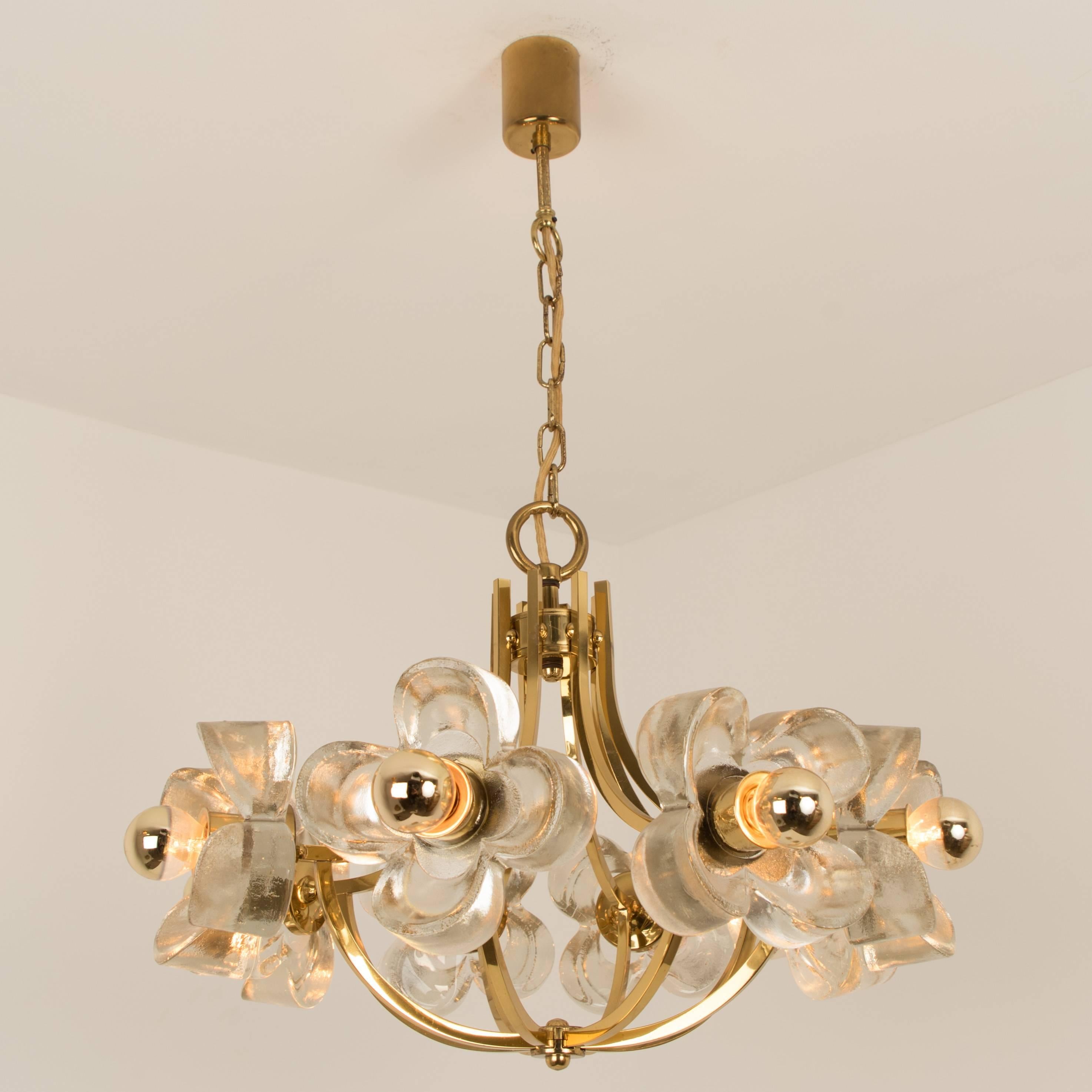 This ceiling light was designed  by  Simon and Schelle, featuring a rectangular brass base and eight massive glasses in the shape of a four lobed flower. 

Dimensions: 
Hight 15.75( 40cm) total 51.18( 130 cm)
Diameter: 23.62(60 cm)
 
Very good