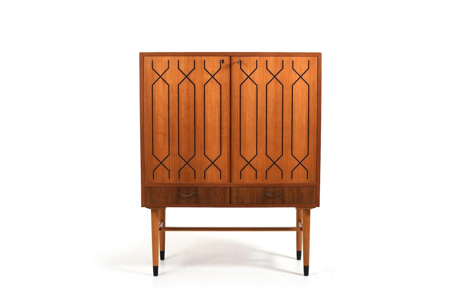 Very nice IKEA cabinet in teak, birch and other wood from the 1950s. In front with 2 doors. Behind them with drawers and shelves. Black parts on doors. In the good old Ikea quality!