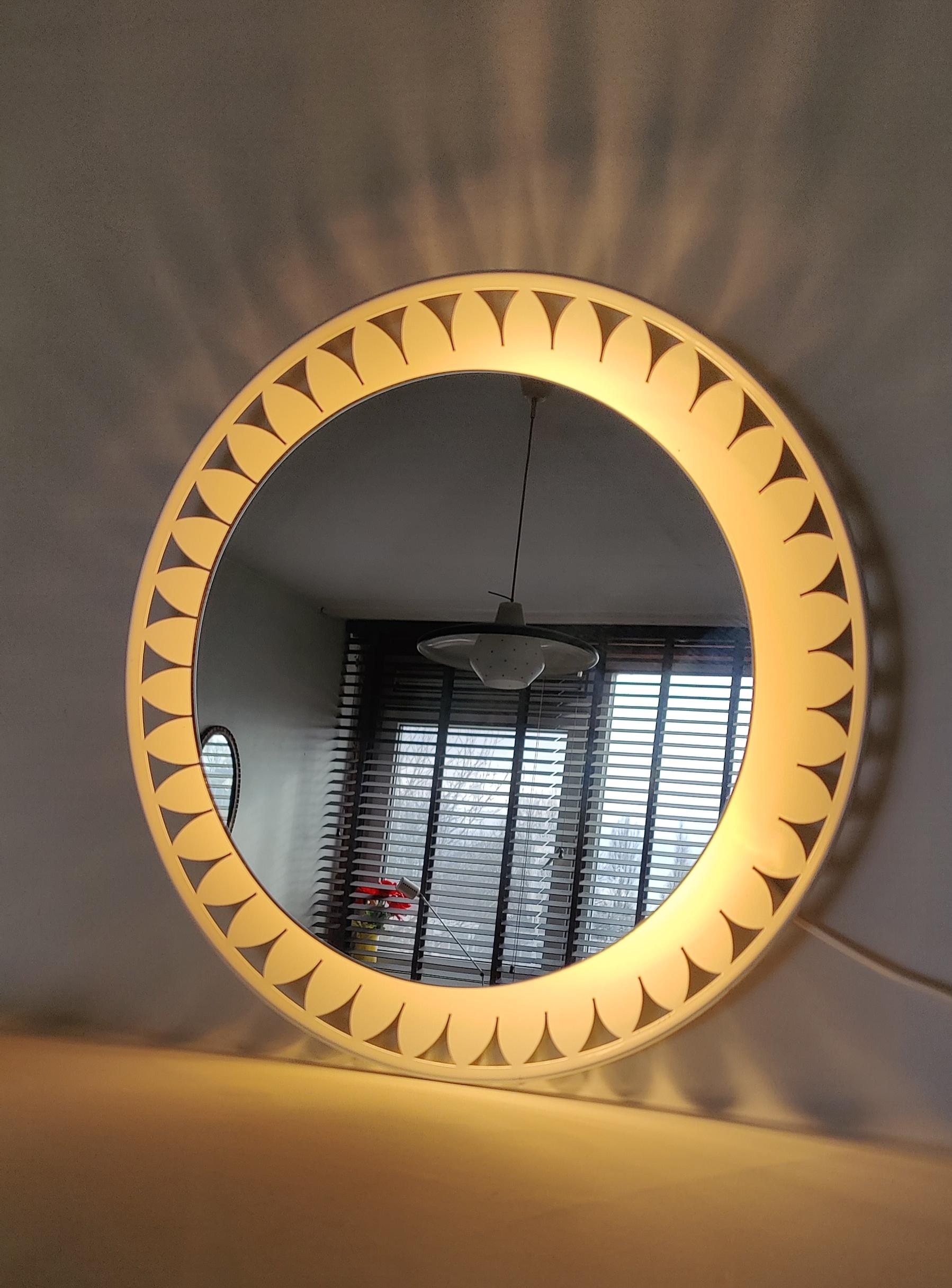 Hillebrand leuchten fabrik  mirror by Ernest Igl from the fifties. German artwork. Round mirror in metal and glass. Could be used as wall lamp because of the backlit system composed of three bulbs. 