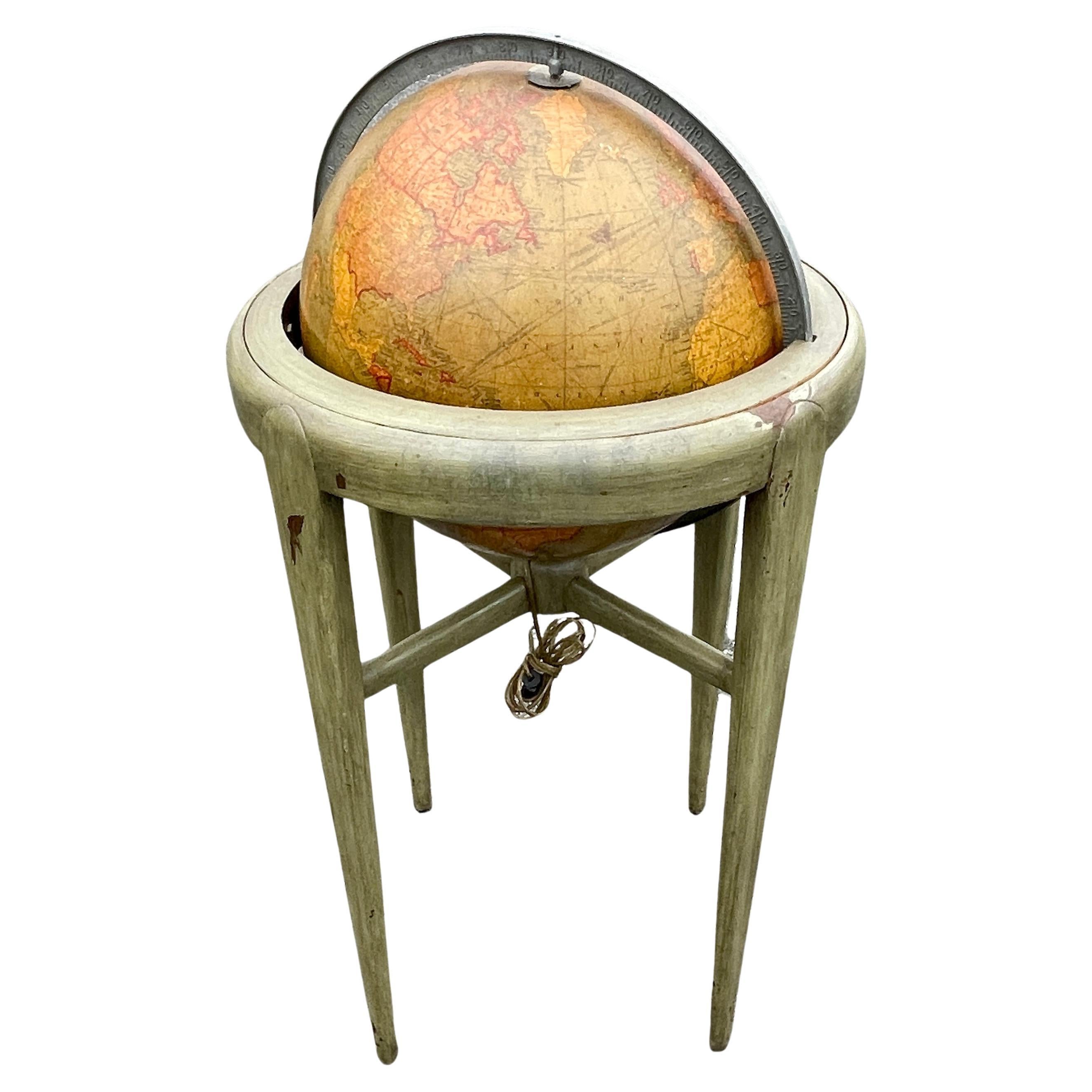 American 1950's back light green painted floor globe by Replogle, Mid-Century Modern.
Remarkable and charming Chicago made world globe featuring an internal light resting on a hand painted wood base in great vintage condition.
Please note that we