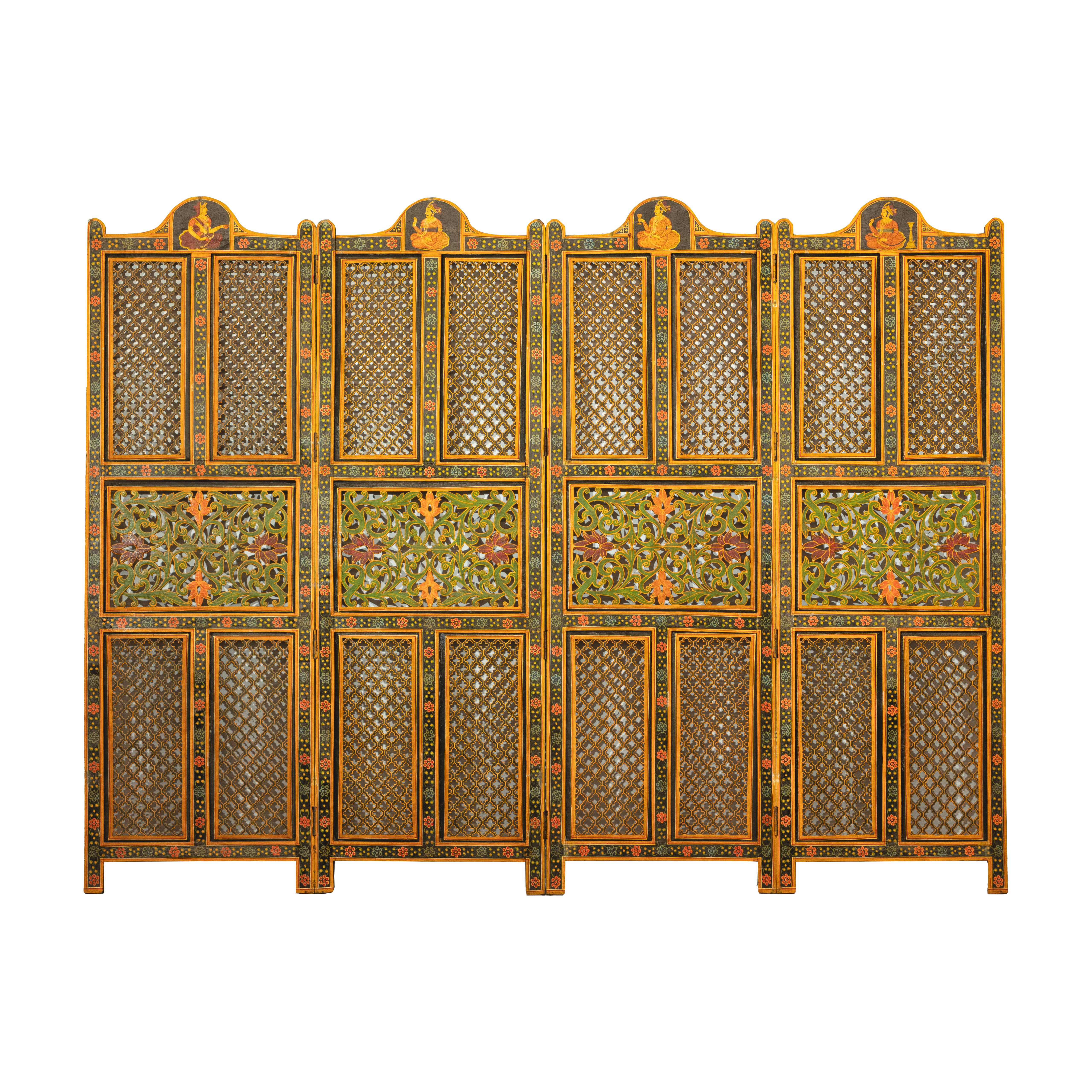 An Indian fretwork four-panel screen from the mid 20th century with polychrome décor. This Indian fretwork screen, crafted from finely carved hardwood, is a vibrant celebration of traditional artistry. Comprising four connected panels, this screen