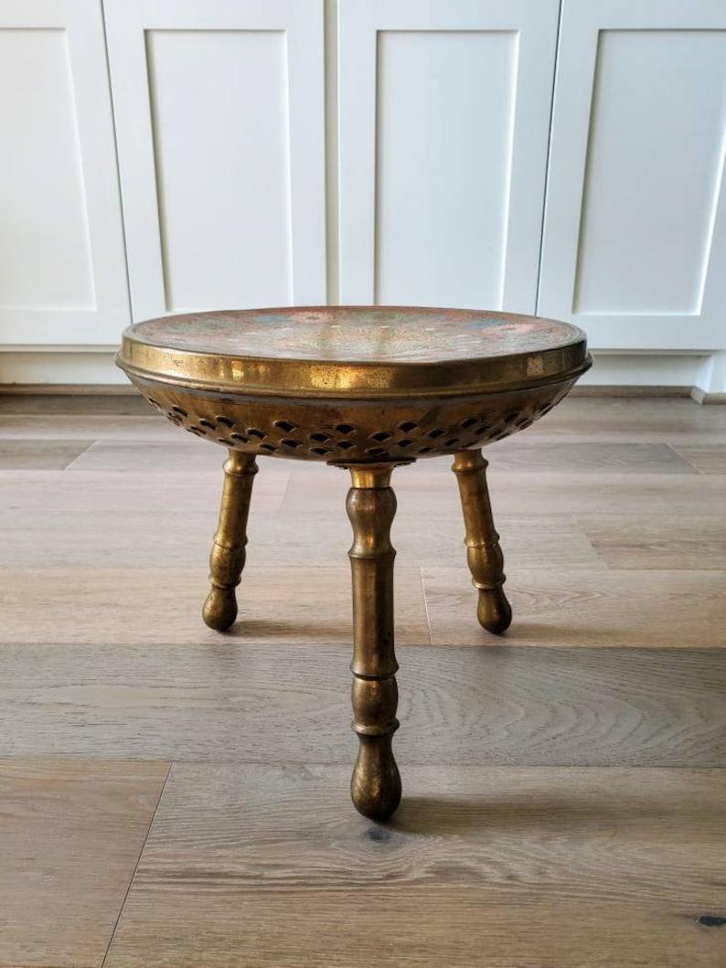 A wonderful hand-painted Turkish solid brass heated low stool ottoman from the mid-20th century. Outstanding vibrant polychrome decorated intricately detailed circular slightly concave top, peacock displaying features and floral motif. Pierced brass