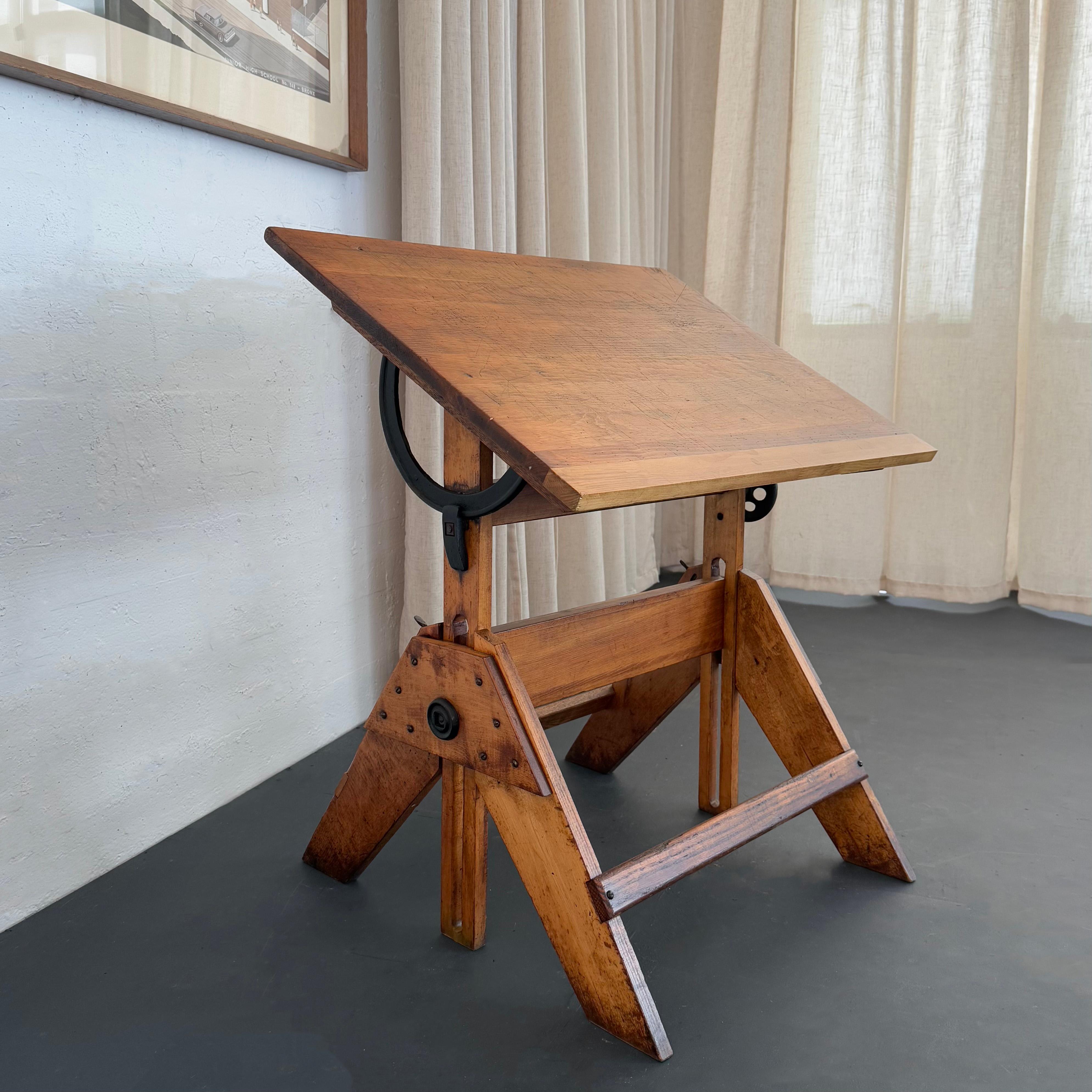 This mid-century industrial maple drafting table is a wonderful compact size with full adjustability. The table features a 31