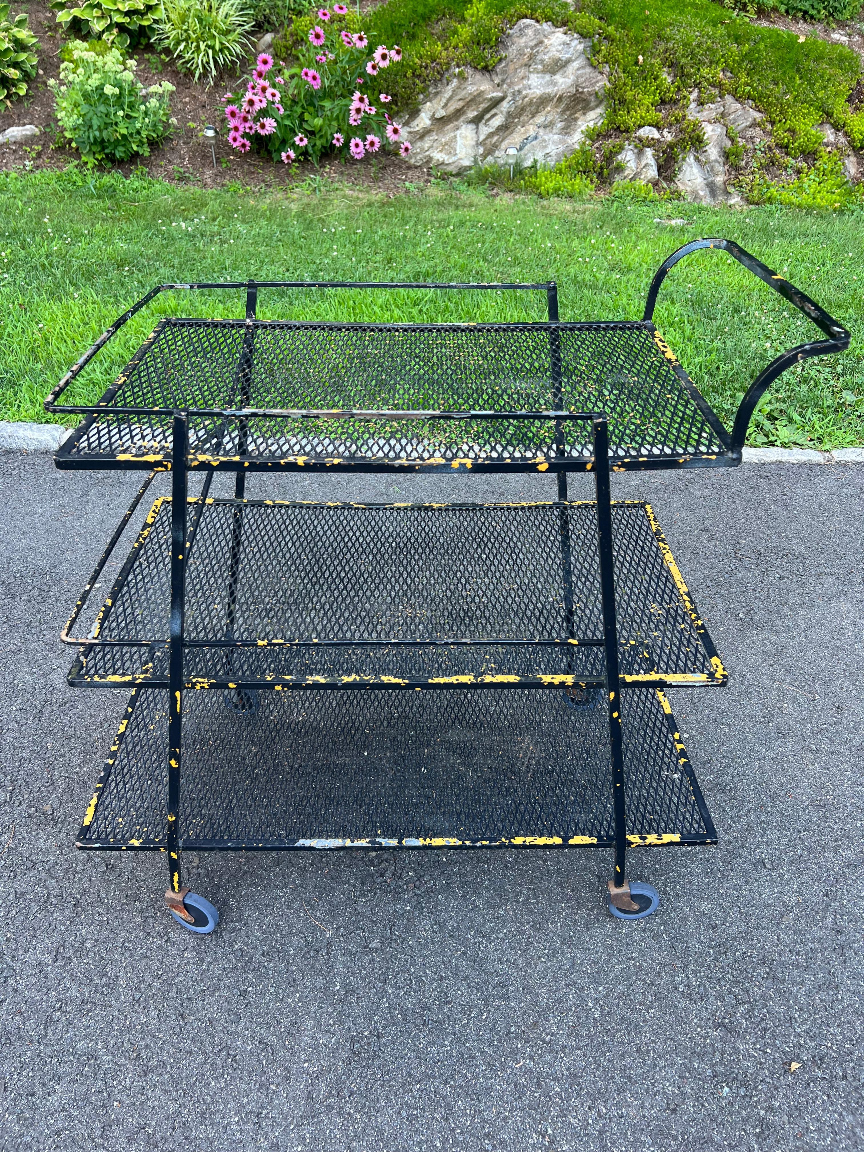 John Salterini for Woodard three tier black wrought iron bar cart. Classic mid century Industrial design. Perfect for that New York Loft. We love the underlying bus yellow with the black to give it that worn , vintage look. Or fully repaint in matte