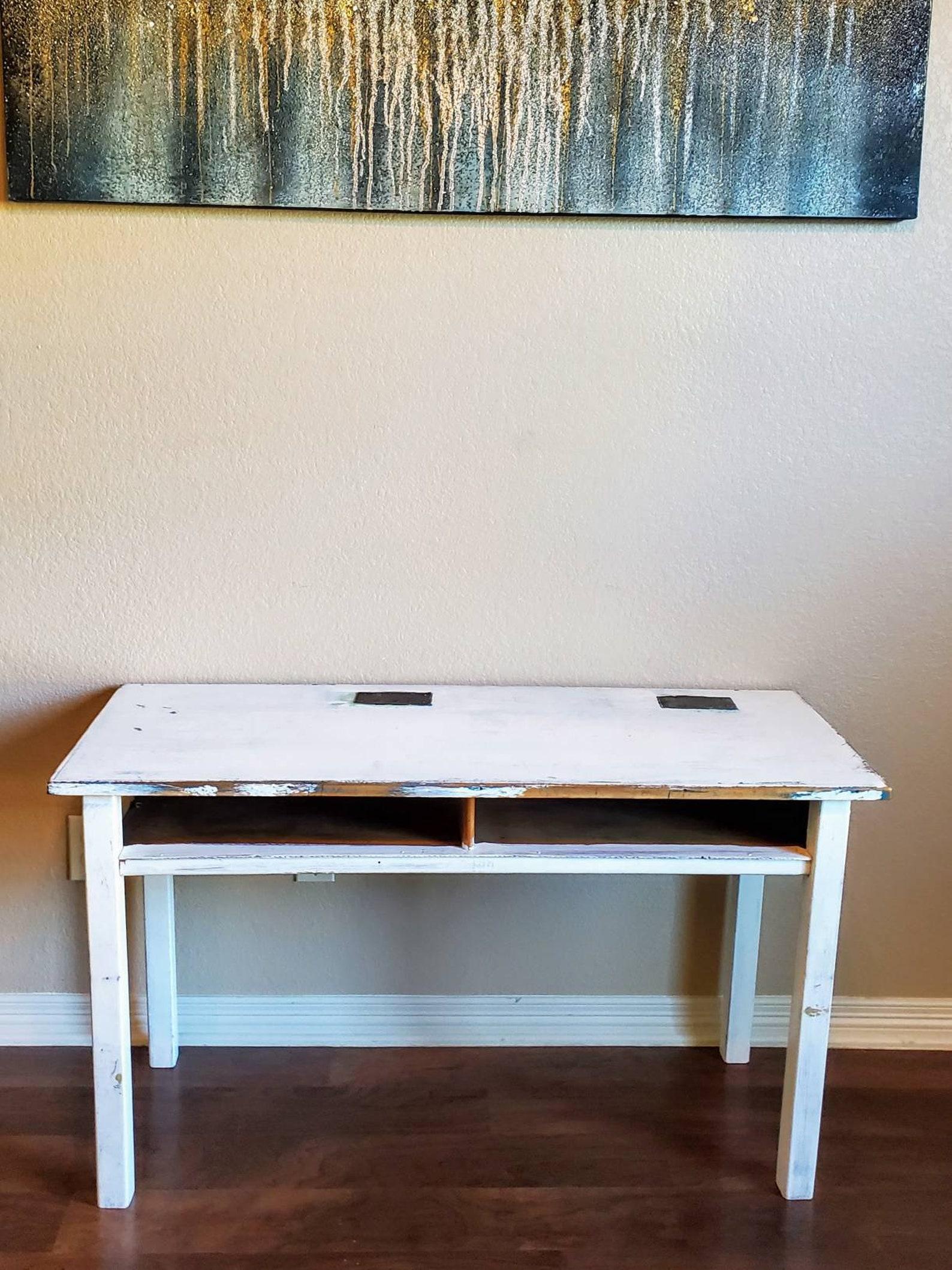 A vintage American Mid-Century Industrial Modern wooden science laboratory tandem desk work table. The distressed painted solid pine table having a bright shabby chic antiqued white finish, two metal plates with reviots accent the slightly