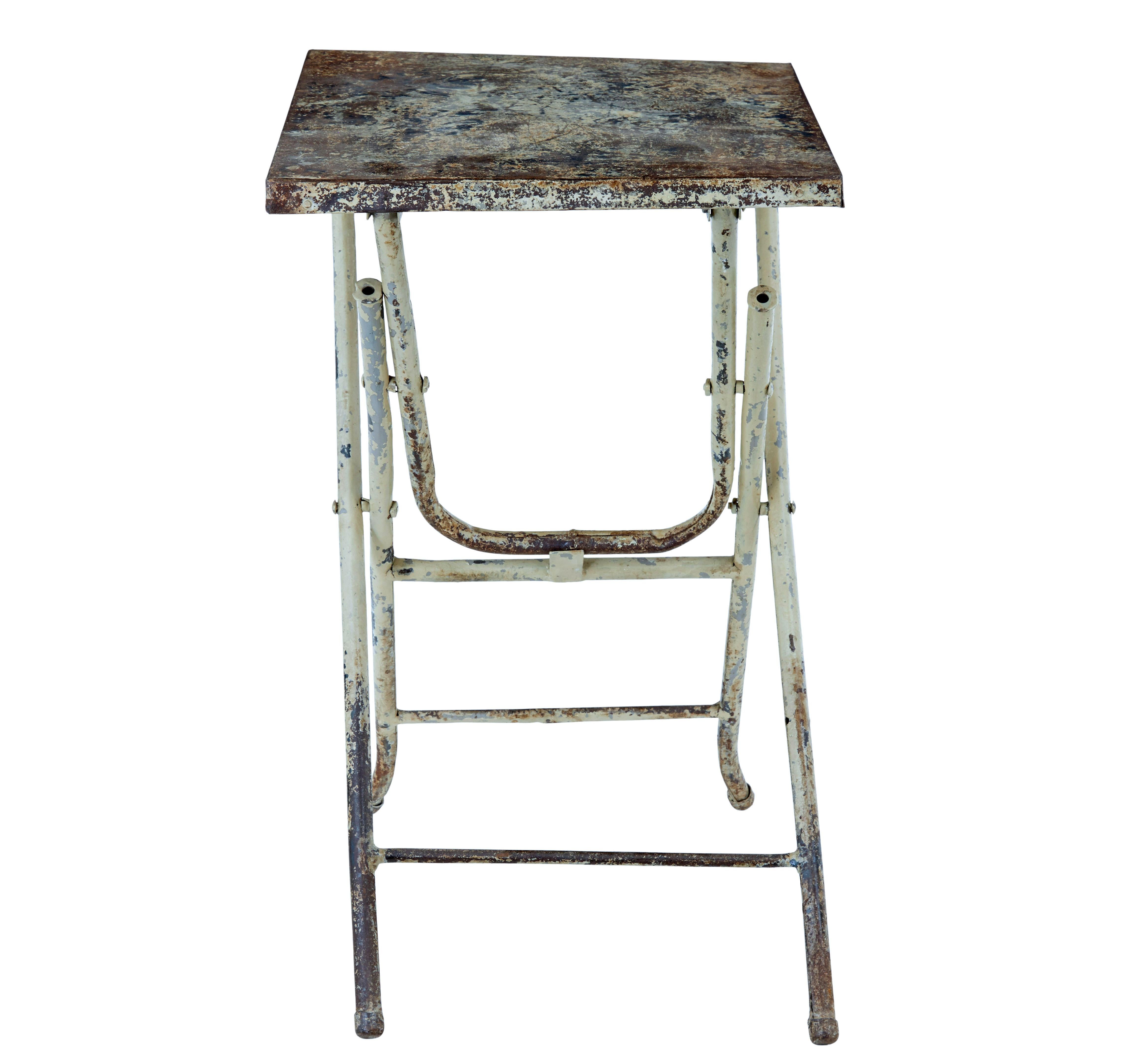 Mid century industrial folding side table circa 1960.

Practical piece of everyday furniture.  Metal table that folds away when not in use.  Makes an ideal table for the garden room, or as a lamp table table in that modern apartment.

Rectangular
