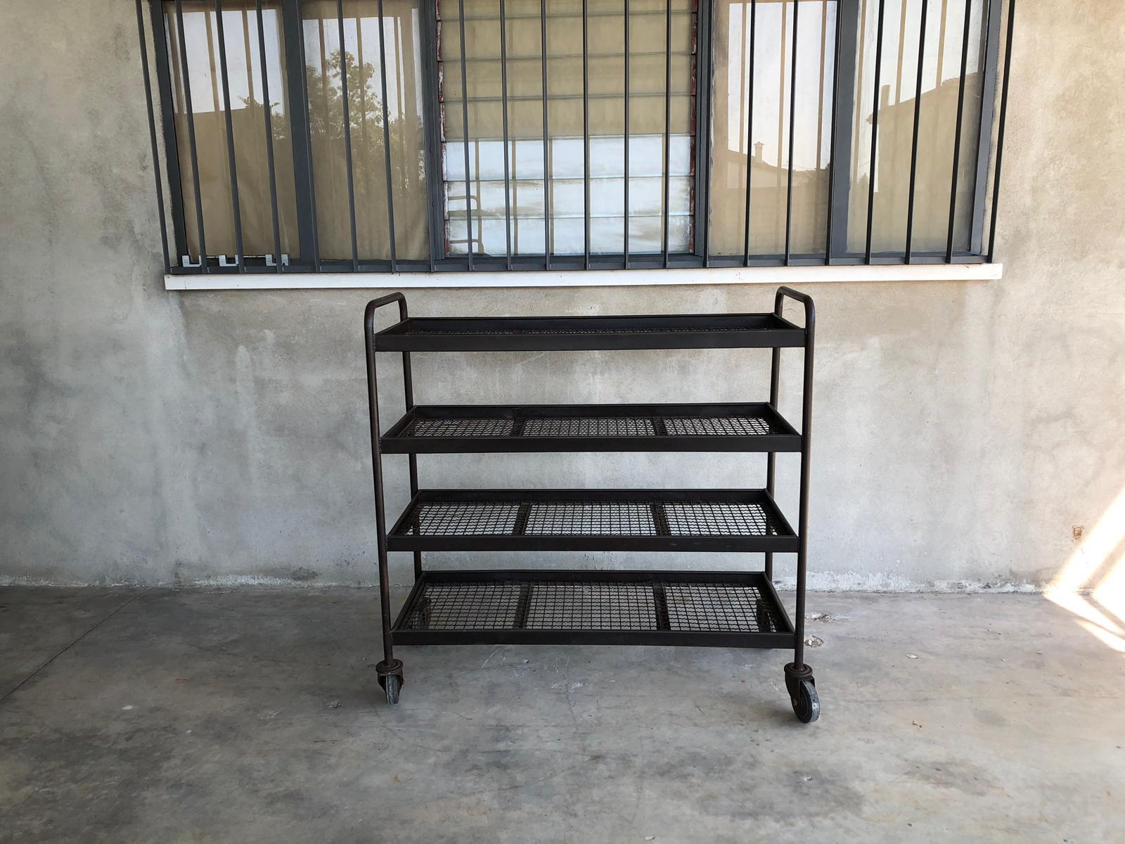 Industrial iron wheeled trays with or without wooden shelves. From Italy from midcentury period.
Trolleys are made of industrial tubular iron with net shelves.
These pieces can be easily set in many different locations: think to a kitchen as