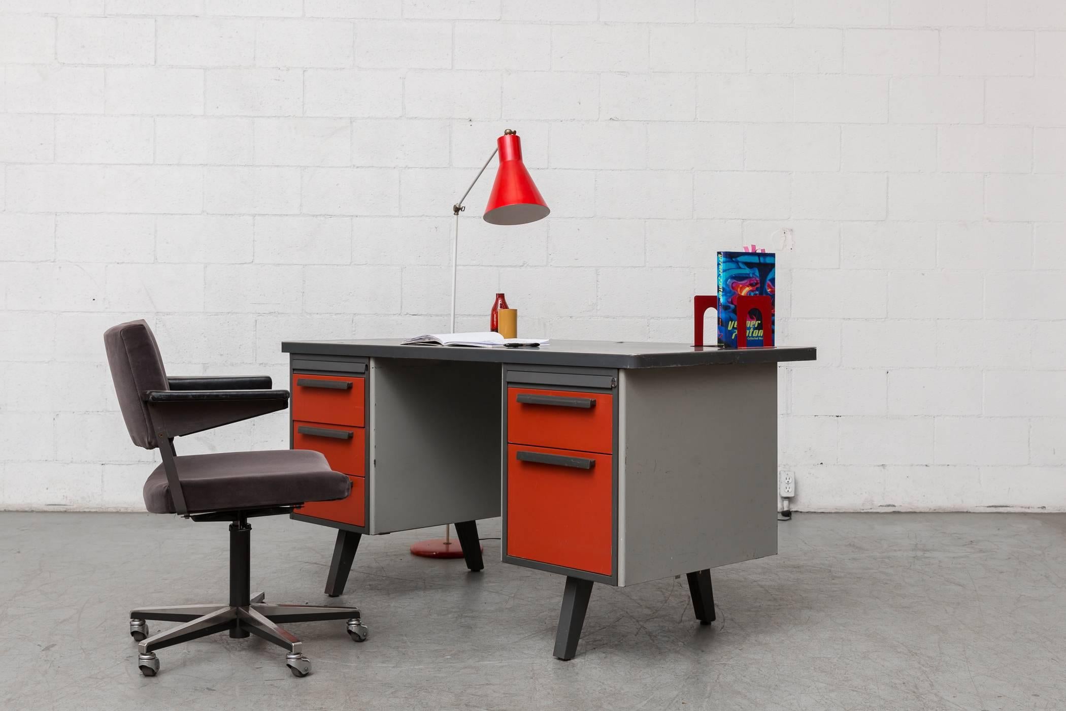 Midcentury Industrial enameled metal framed desk by French Manufacturer Strafor with linoleum top. Drawers are brick red enameled metal: three stacking on the left and one drawer over a file drawer on the right. Linoleum top is in original condition