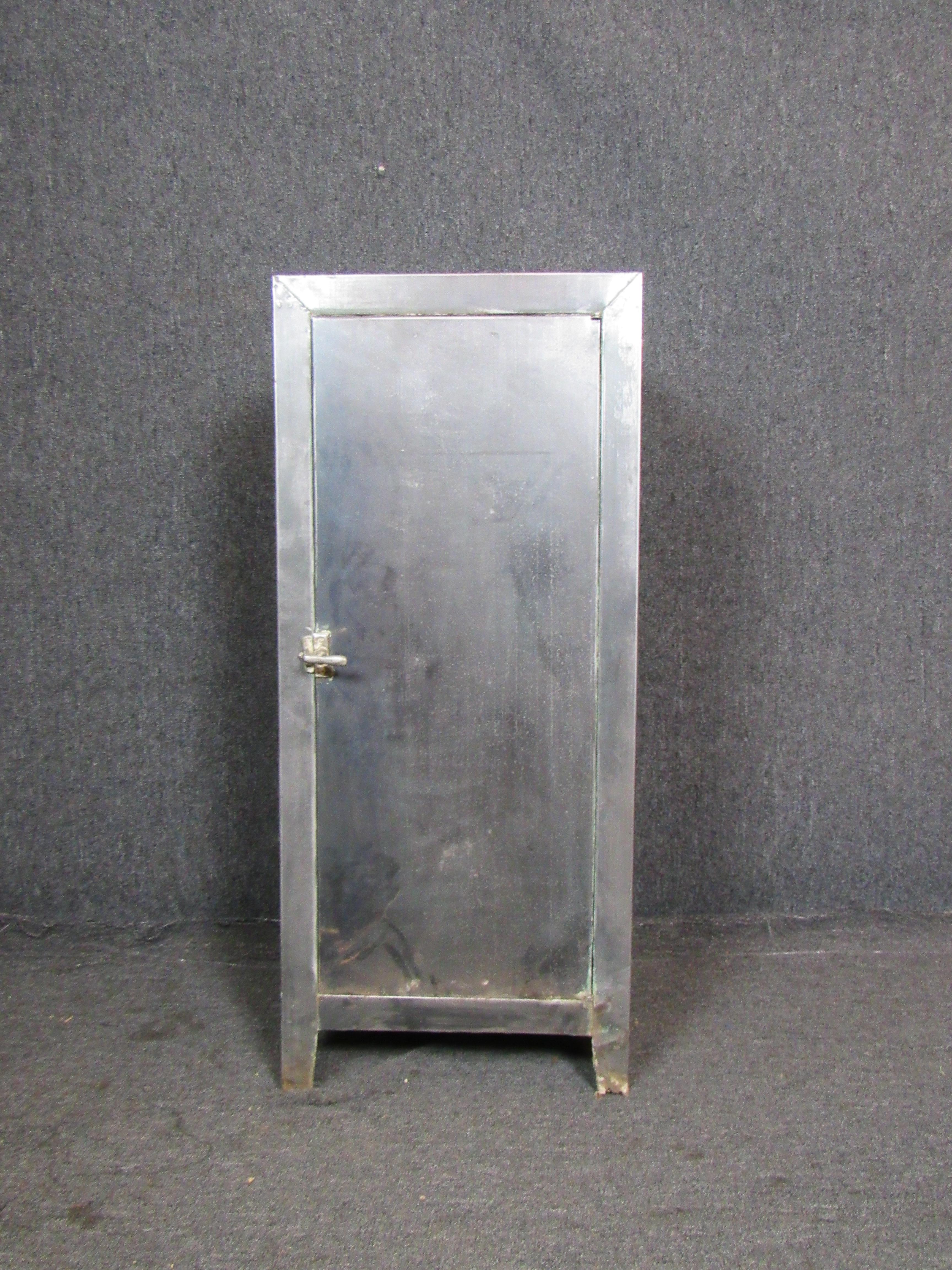 Wonderful vintage medical cabinet, featuring a gorgeous natural patina that makes industrial metal so sought after. A compact footprint makes this cabinet a perfect storage solution for any small space- in the home, or at work. Adjustable shelves