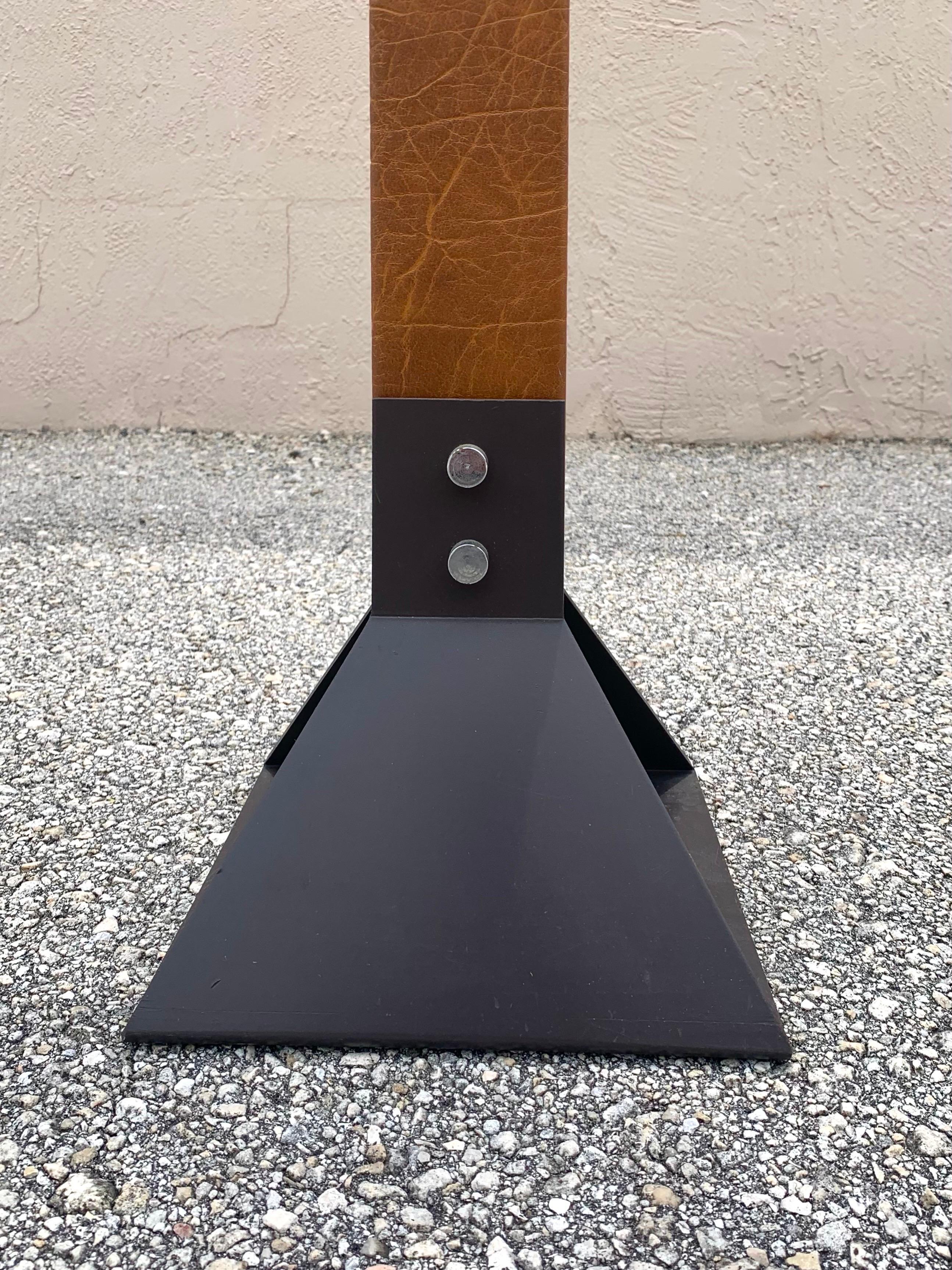 Late mid century era industrial floor lamp. Steel based and a leather wrapped piece of solid wood make the lamp. Chrome switch. The color is a beautiful rich brown with great texture in the grain of the leather. Stitching on the backside going all