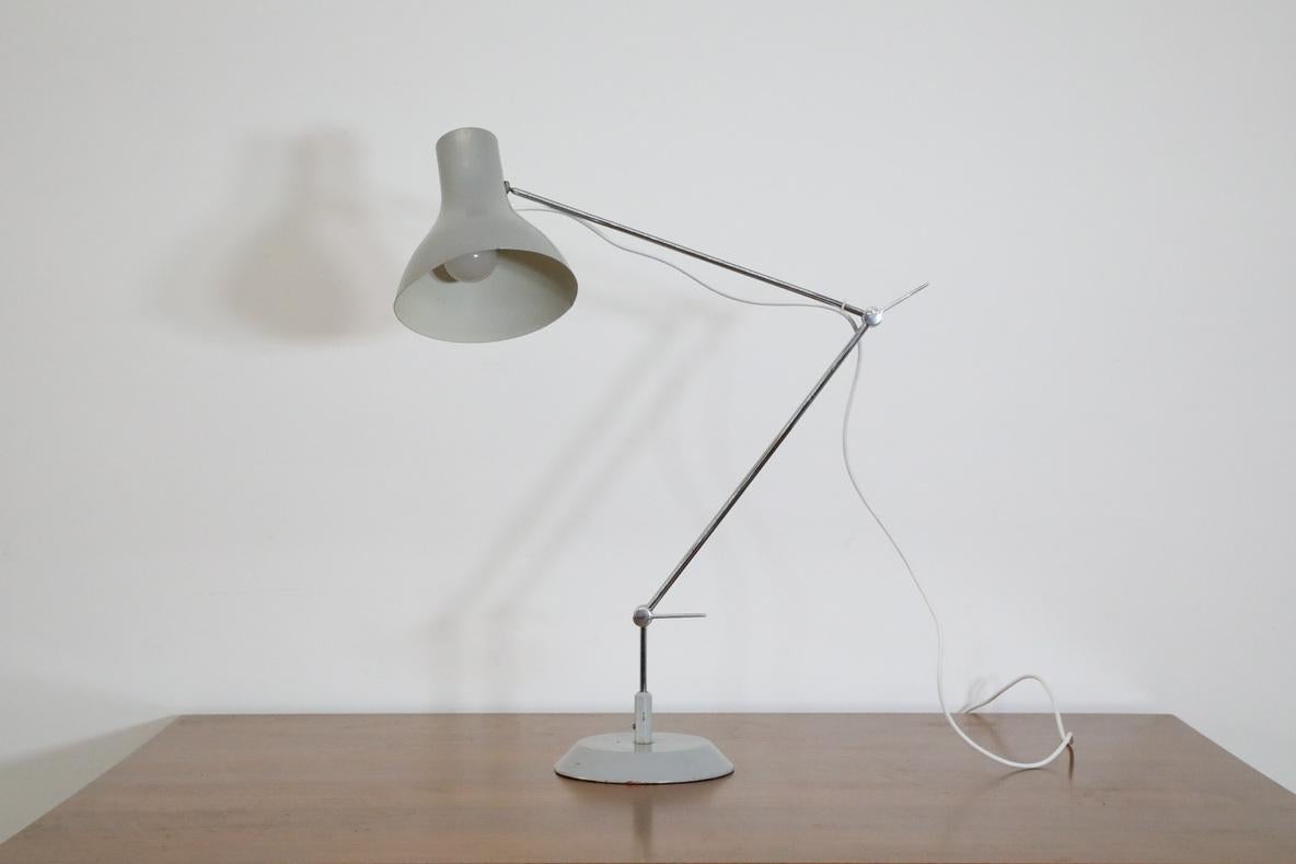 Mid-Century Industrial task lamp by Napako circa 1950's. Satin gray enameled aluminum shade on multi-adjustable chrome stem and a weighted metal base. In original condition with visible wear and scratching consistent with age and use. Similar table