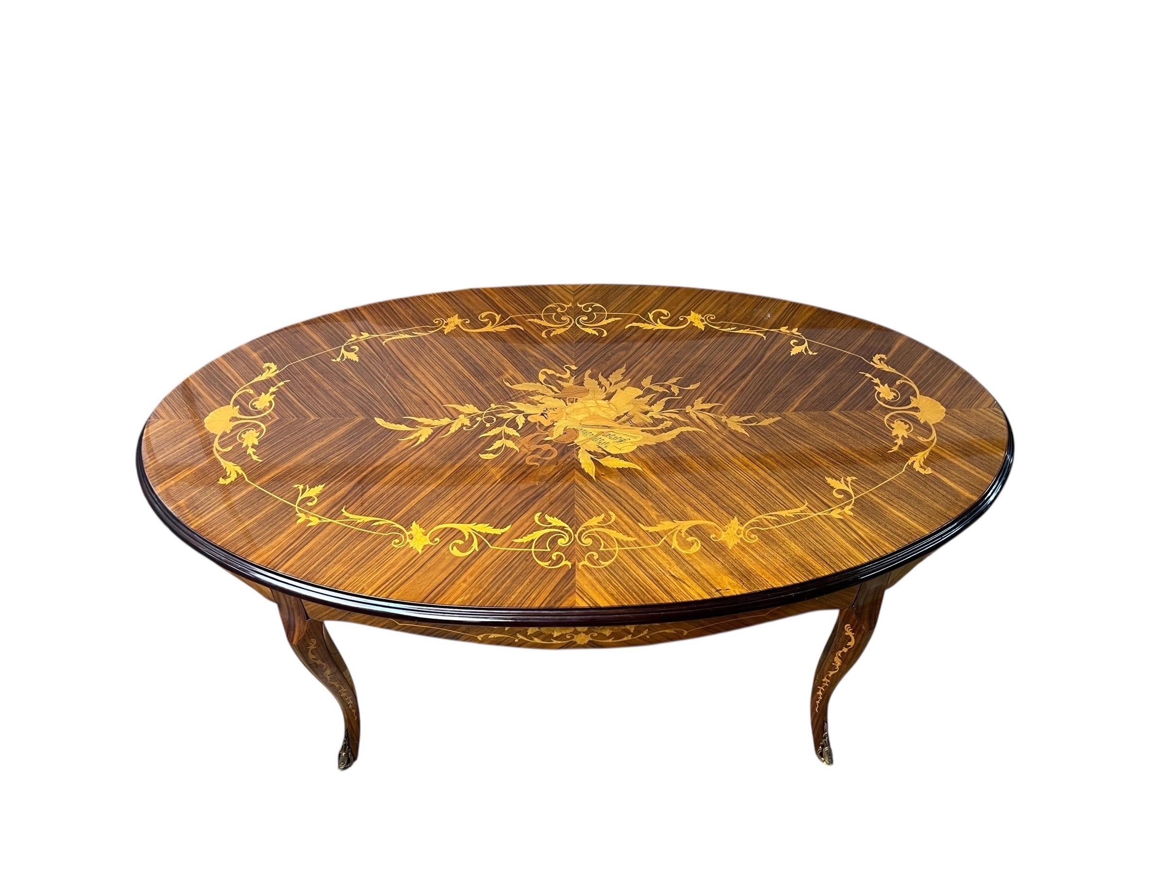 This is an absolute gorgeous inlaid Italian table with brass feet.