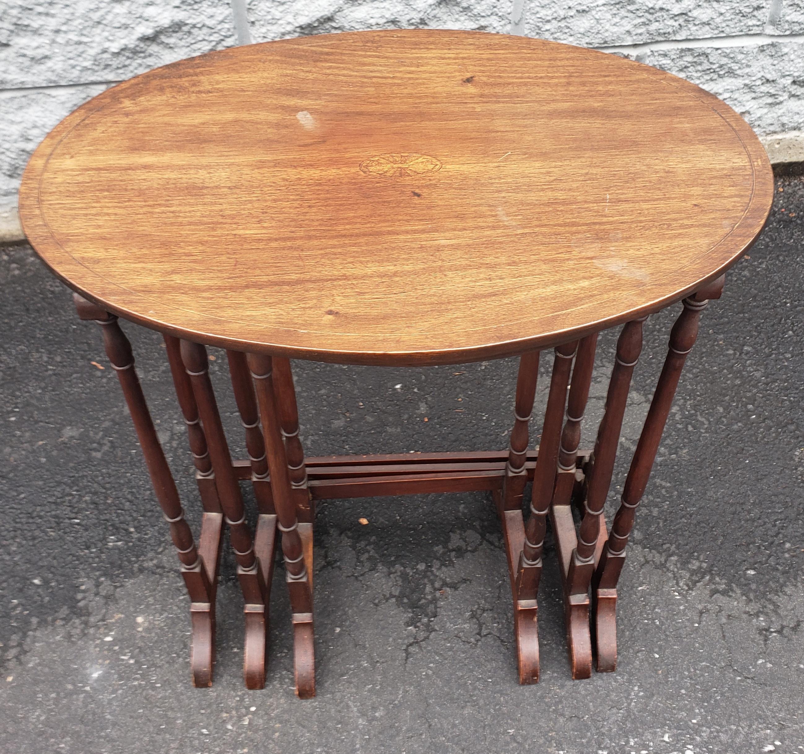 A trio of mid-century Inlaid Mahogany Faux Bamboo Nesting Tables.
The measures measures:
Larger table is 22.5