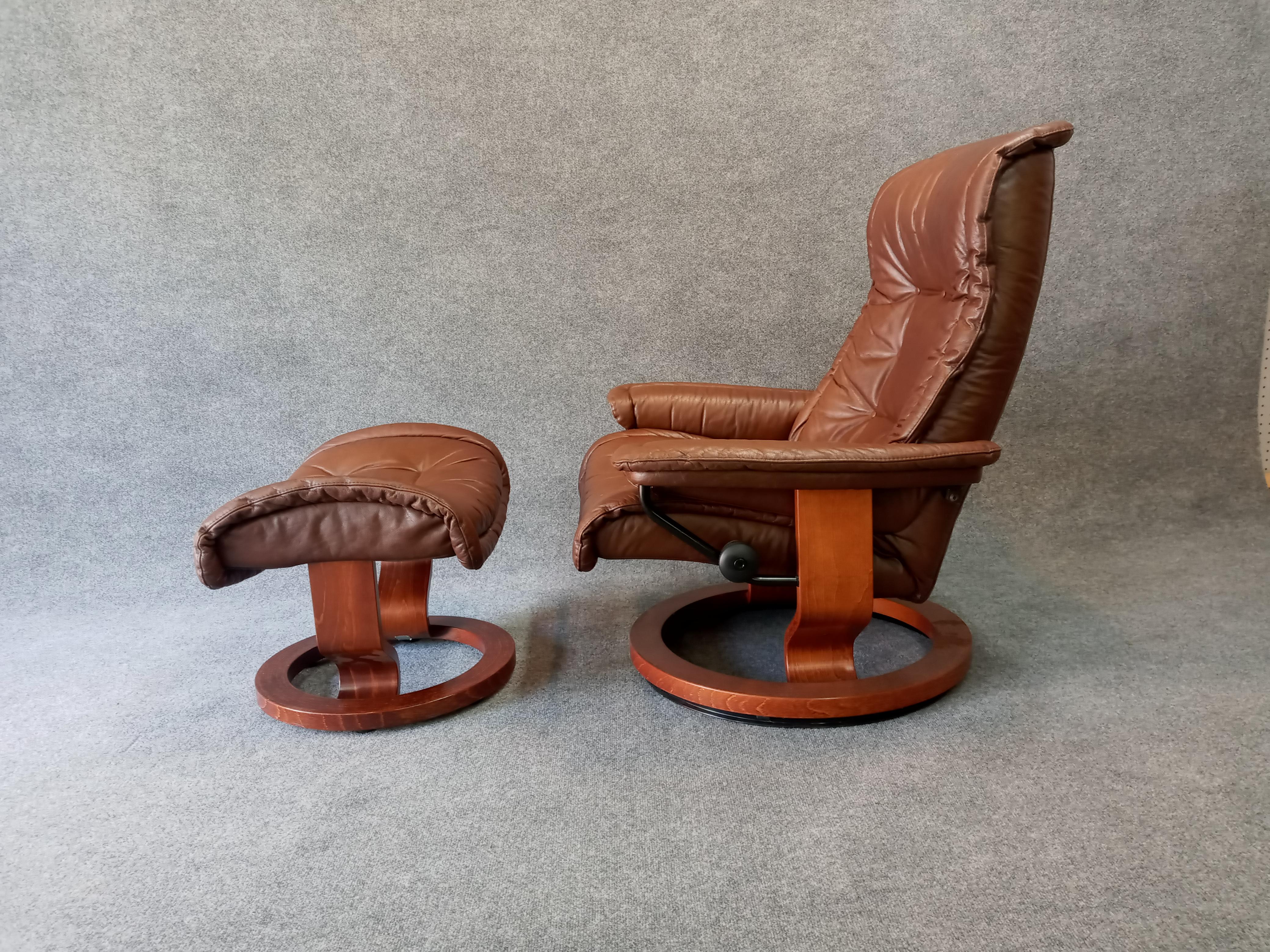 A vintage example of the modern classic reclining lounge chair and ottoman in tobacco brown leather with stained plywood base. Chair tilts and swivels. Ottoman retains original manufacturer label.

Very good vintage and original condition. No breaks