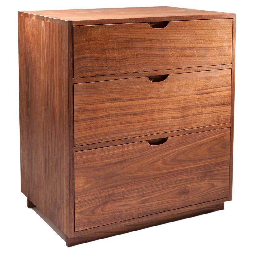 This mid-century inspired dovetailed dresser in walnut was originally designed for one of our first studio patrons. He appreciates exposed joinery and so dovetails were a natural choice. We dovetail the sides to the top for this dresser both for