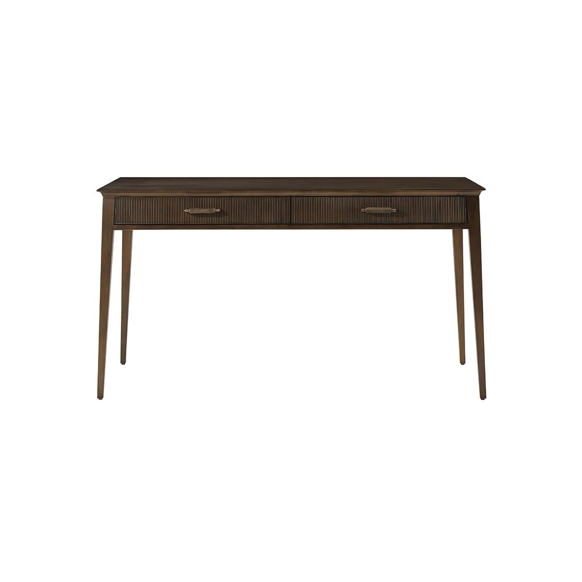 This midcentury inspired writing desk is perfect for those looking for a blend of elegance and modernity in their home office. Crafted from Prima Vera and finished in our Bistre finish, it features a sophisticated tapering Silhouette and reeded