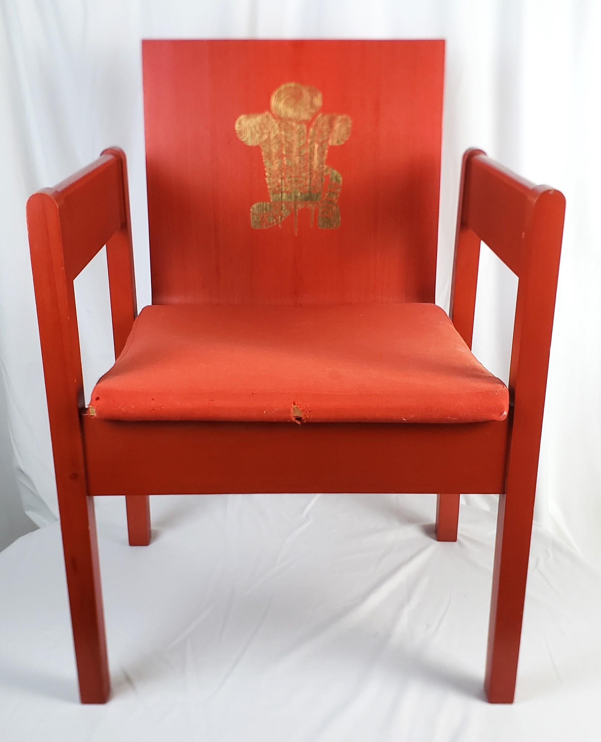 This chair was designed by Lord Snowden in 1969 and produced by Remploy for the Investiture ceremony of Prince Charles, and done in the period Mid-Cetury Modern style. The chair is made of ash with a bentwood back and painted in a bright red with
