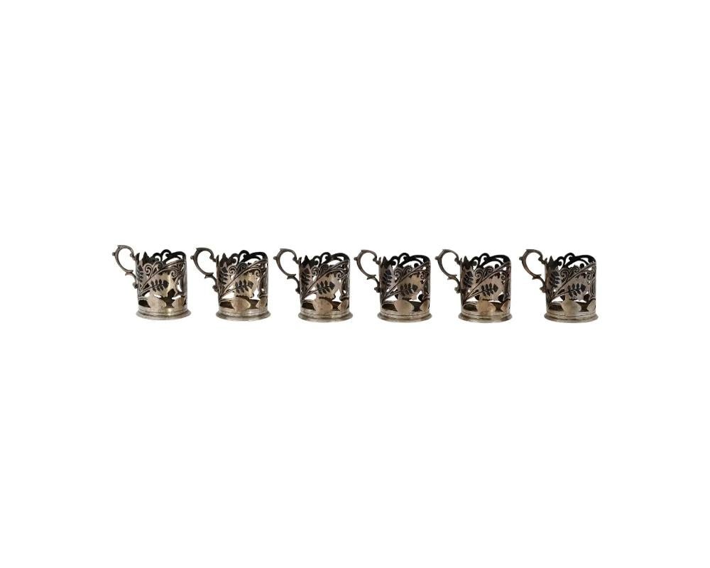 An early to mid 20th-century Iraqi silver glass holders. A set of 6 items. Pierced body, floral niello decoration, figurative handle. Total Weight: 496 grams. Oriental Arabic Islamic Decor, Collectible Silverware, Tableware, Tea And Coffee