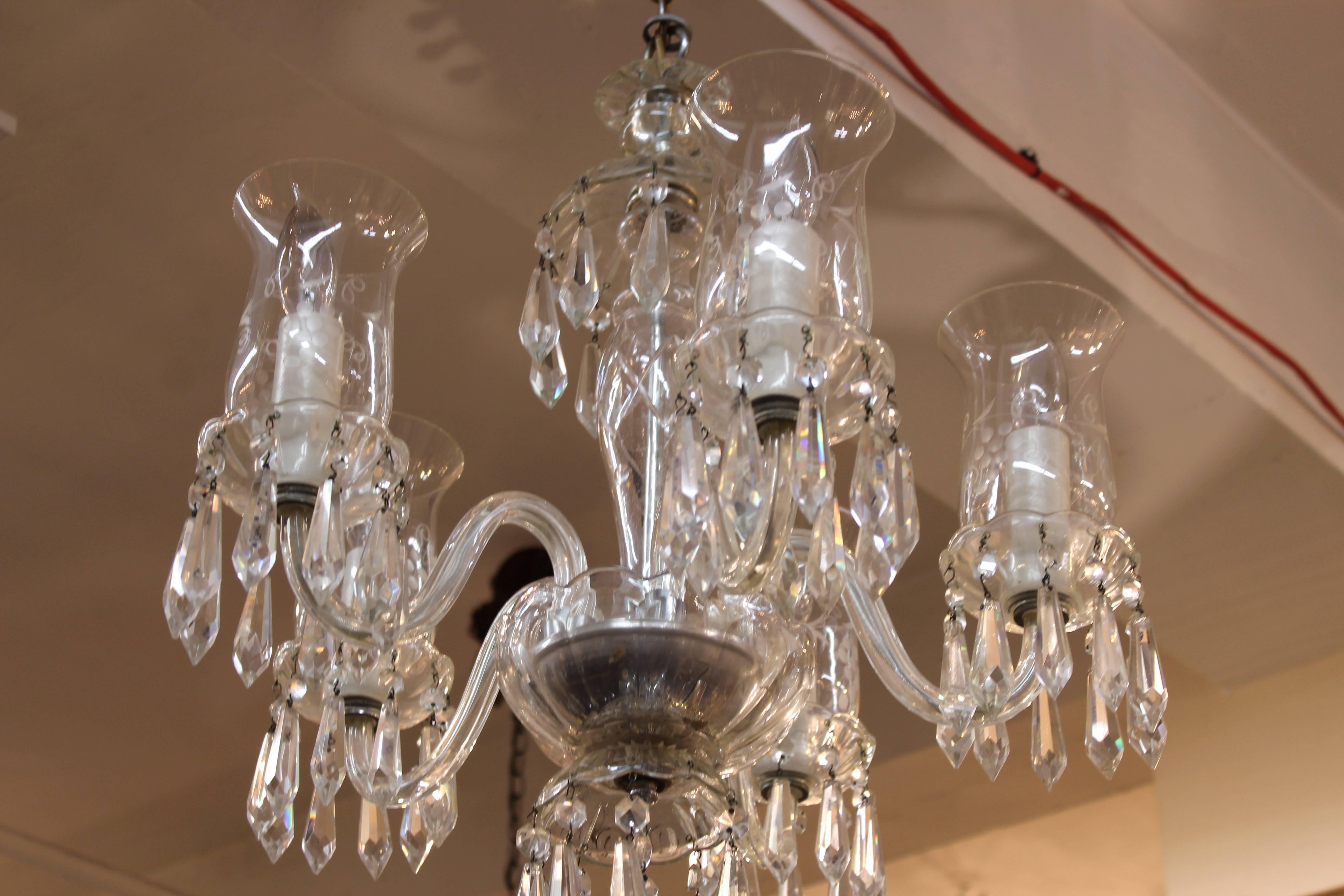 A midcentury Irish chandelier in glass and Lucite, manufactured in the 1940s in Ireland. The piece is in good condition, with one of the drops missing from the centre.