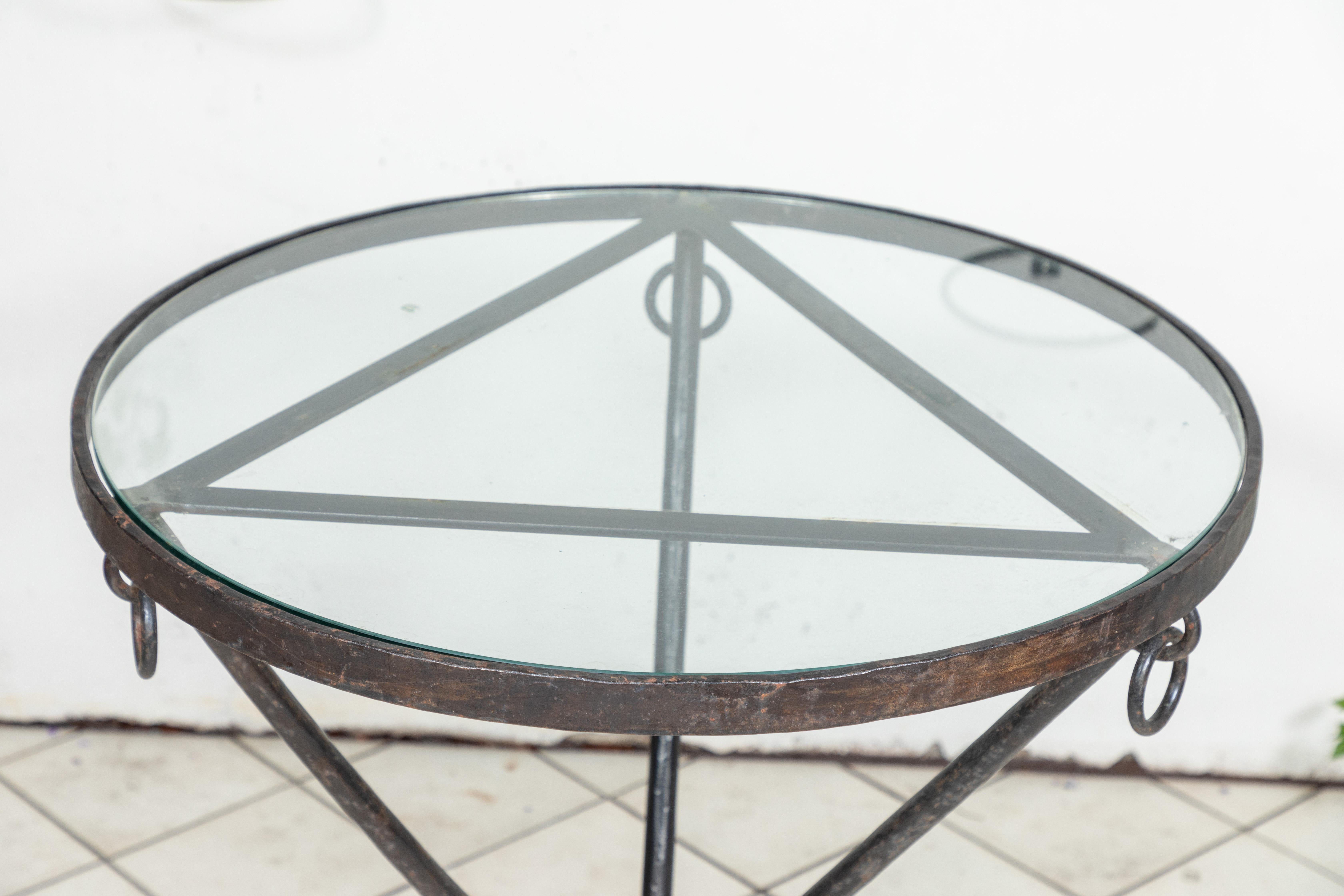 Mid Century iron and glass round table with ring details, circa 1950.