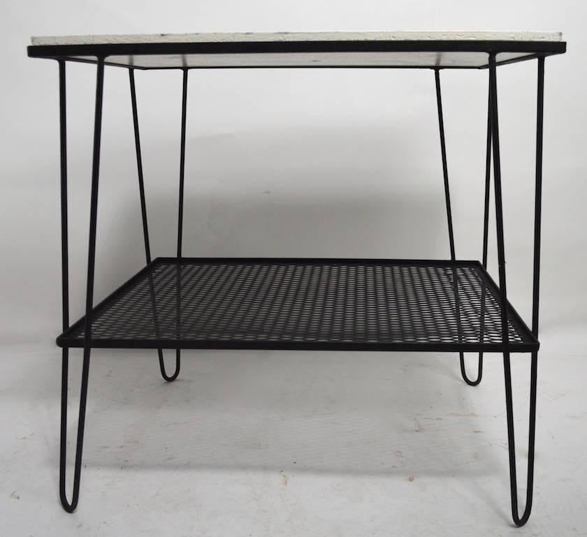 Black iron base with hairpin legs and a shelf supports a white painted Masonite table surface. Clean, and ready to use condition, top easily removed if you prefer to change the glass etc. nice usable scale.