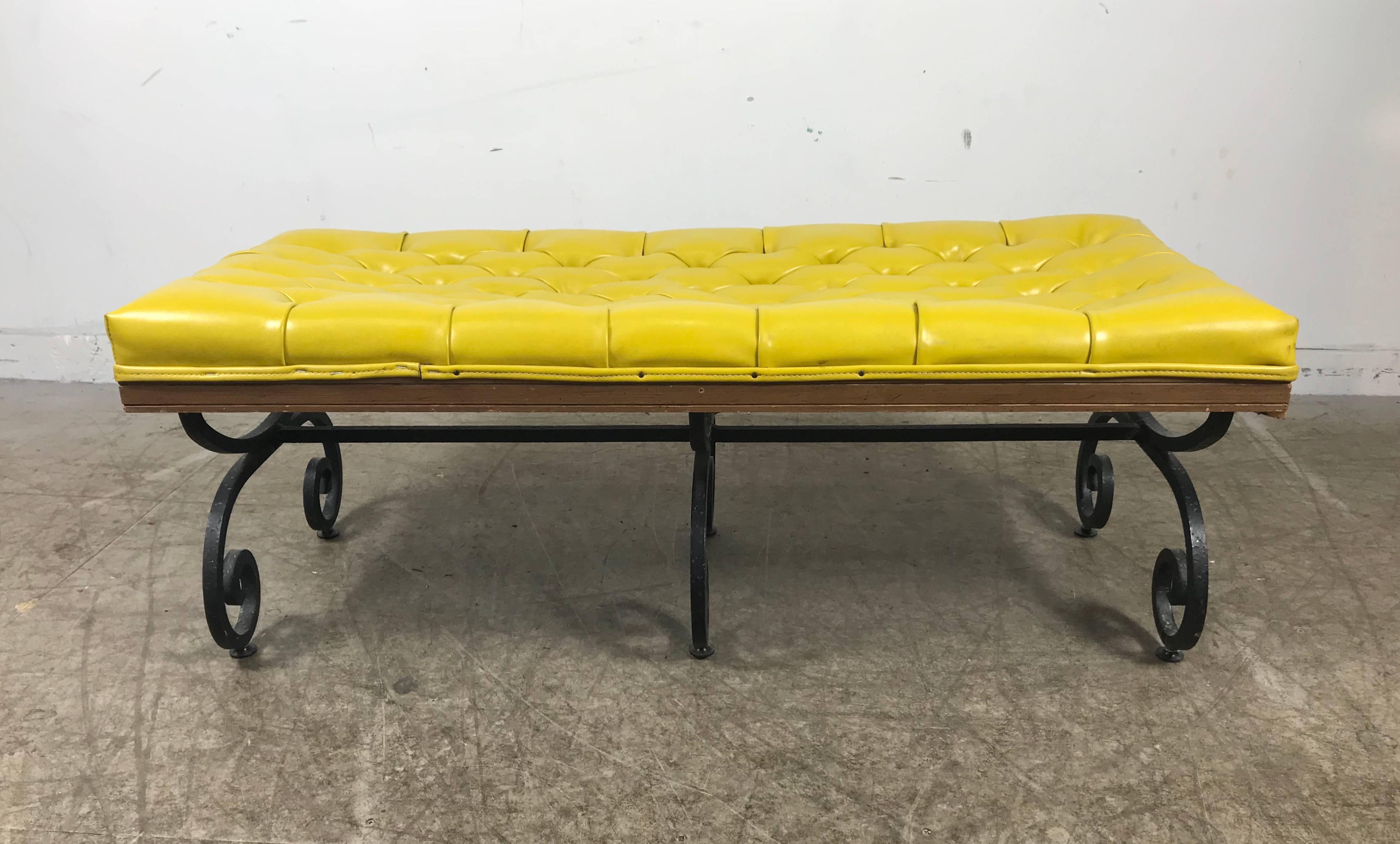 Midcentury iron and tufted leather bench by Gilliam Furniture Inc. Outrageous mustard color tufted leather. Heavy gauge hammered regency style wrought iron wood trim.