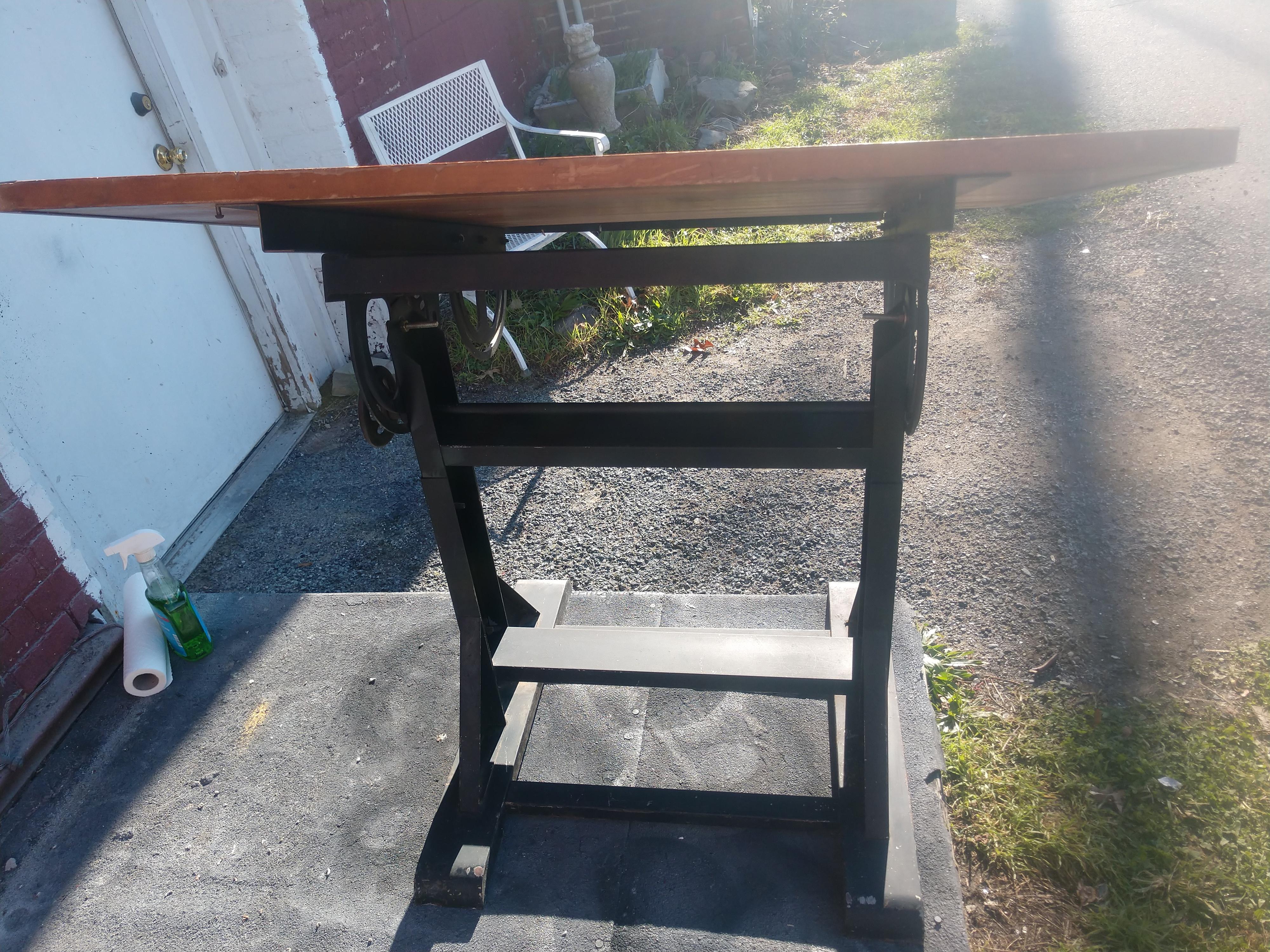 Fabulous iron and steel base with a 31 x 42.25 inch top, 1 inch thick board framed with metal sides and a pencil tool holder up front. Raises up from 33.5 to 43. In excellent vintage condition with minimal wear.