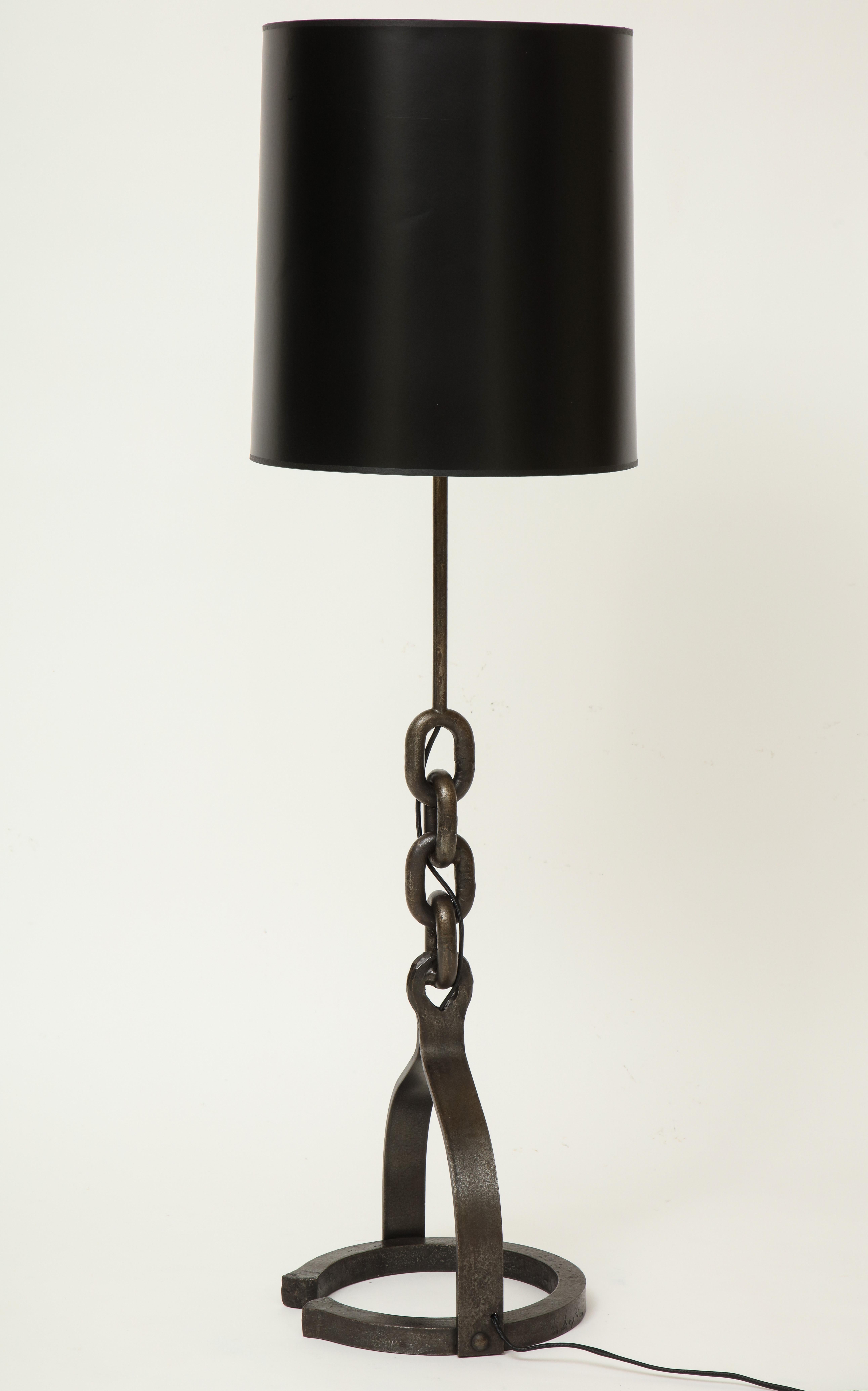 Iron chain attributed to Adnet Horshoe tall lamp, France 

Beautiful and heavy iron chain link lamp with horseshoe bottom. In the style of Franz West or Adnet. Large scale table lamp
Elegant Piece. Imported from France. Late Midcentury. Shade not