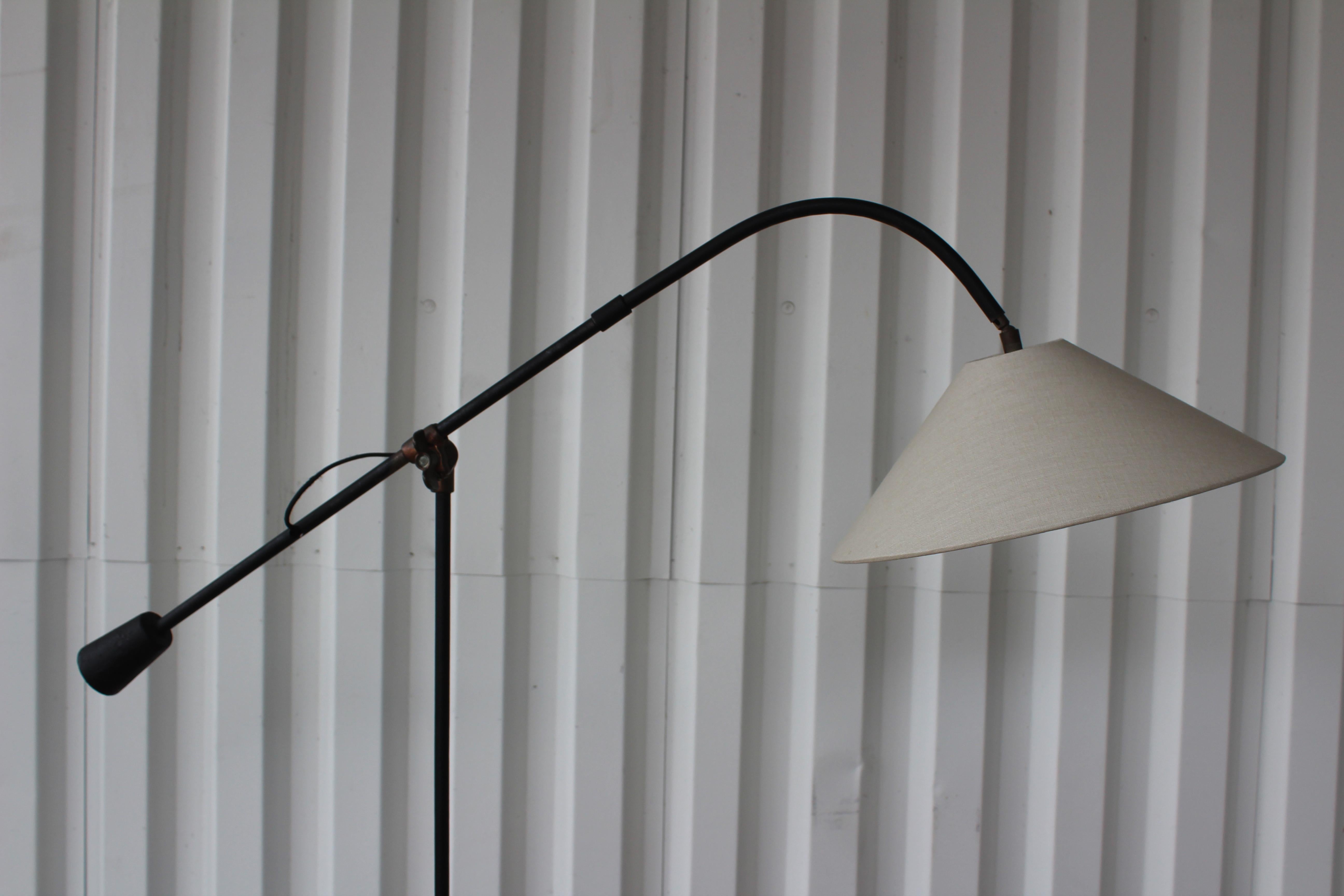 Vintage midcentury iron counter balance floor lamp, France, 1950s. Newly rewired and fitted with a custom made shade in off white linen. Iron shows age appropriate patina. Brass clamp allows the lamp to be adjusted.
