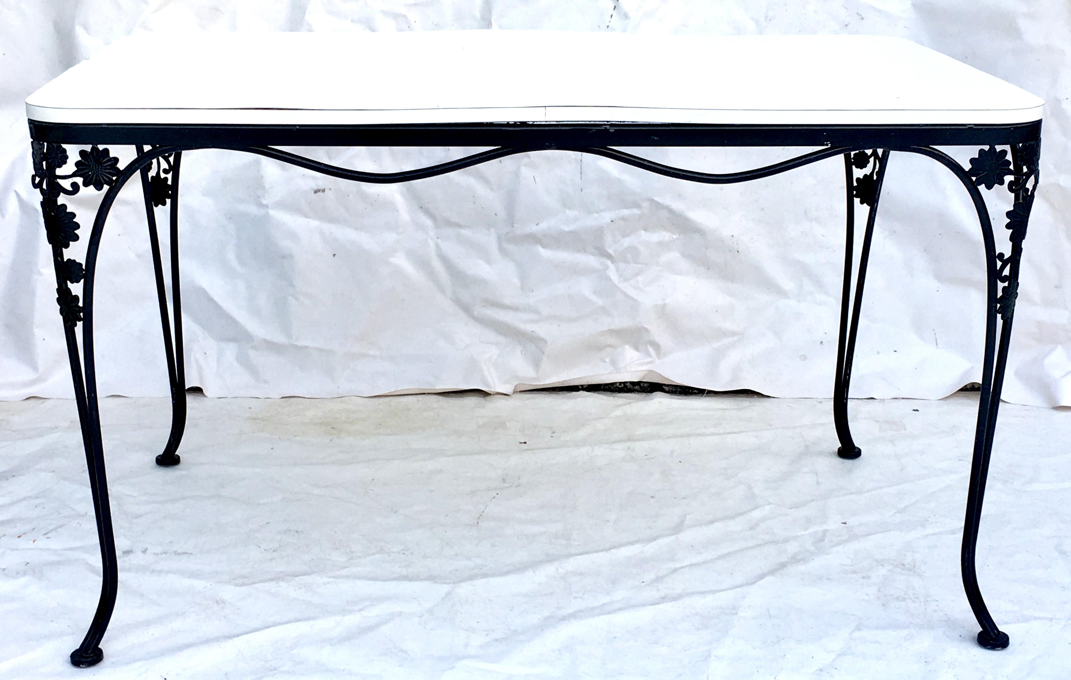1950'S Wrought Iron black floral and vine motif rectangular dining table. Features a daisy motif on curved legs. White laminate top, slightly warped.