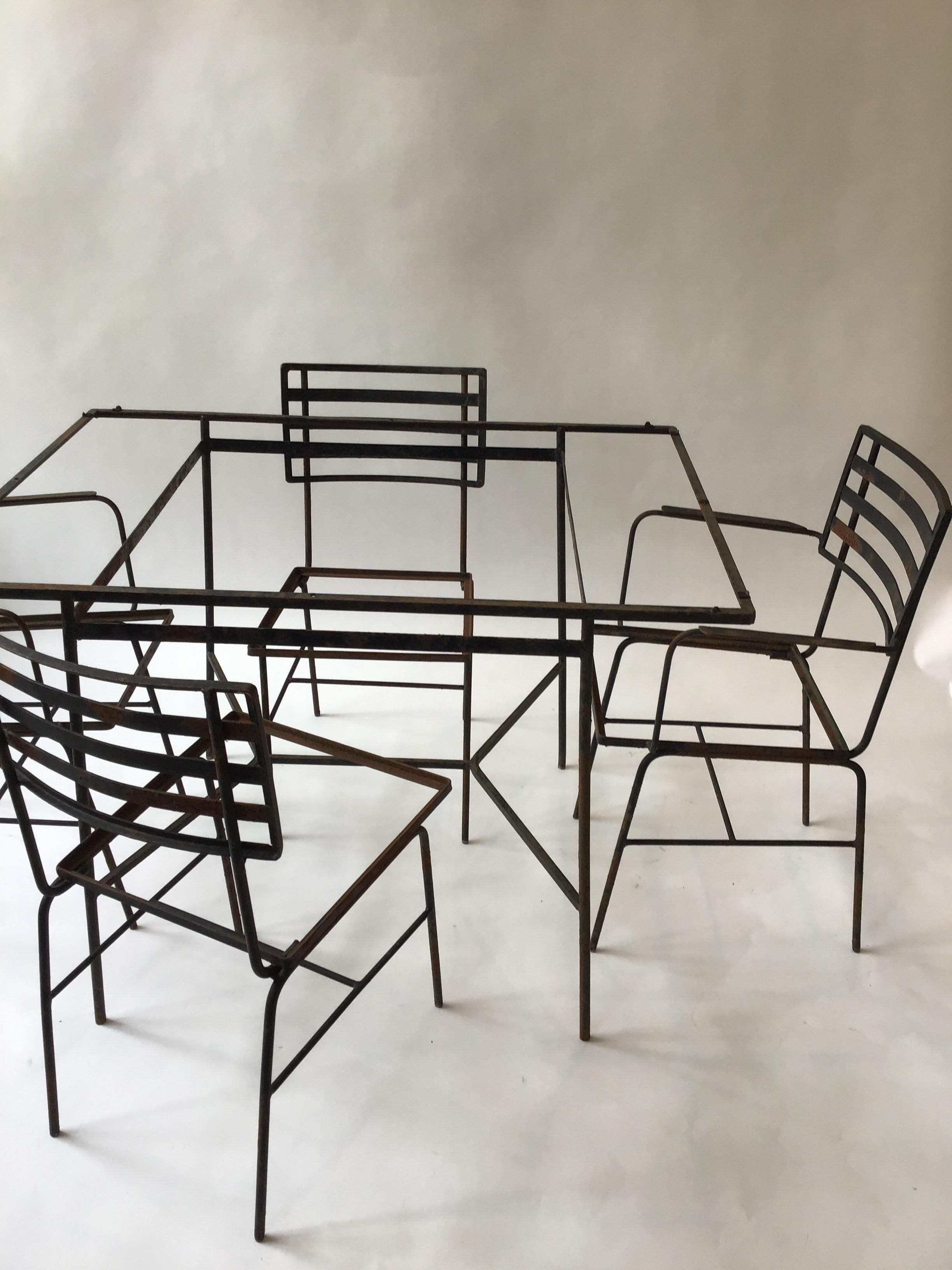 1950s iron outdoor set. Very machine age looking. Table, 2 armchairs, 2 side chairs, no glass.