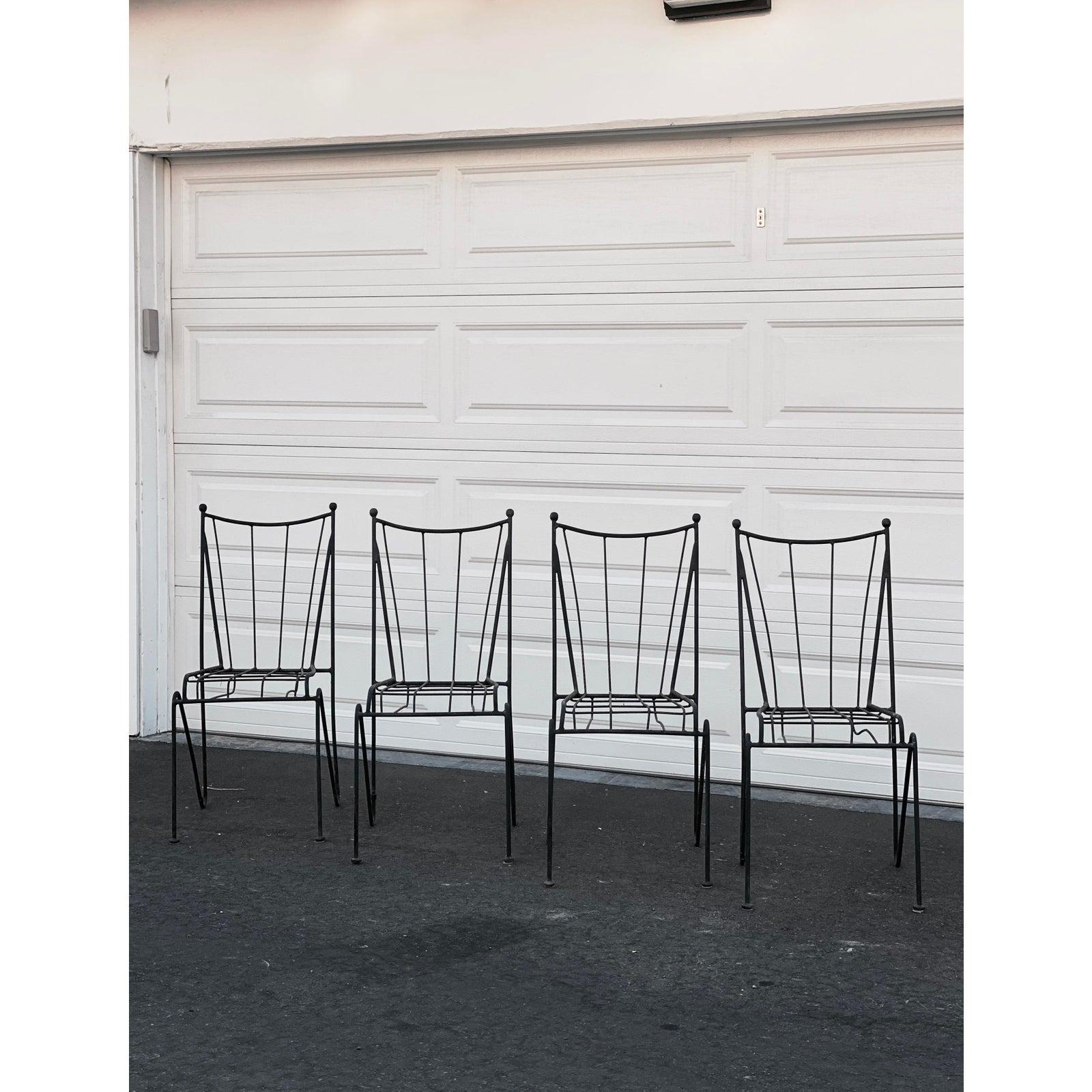 A set of four beautiful mid-century wrought iron outdoor and patio dining chairs from the 1950s attributed to Pipsan Saarinen-Swanson for Ficks Reed. Chairs are overall in wonderful condition with natural aging and patina to iron.