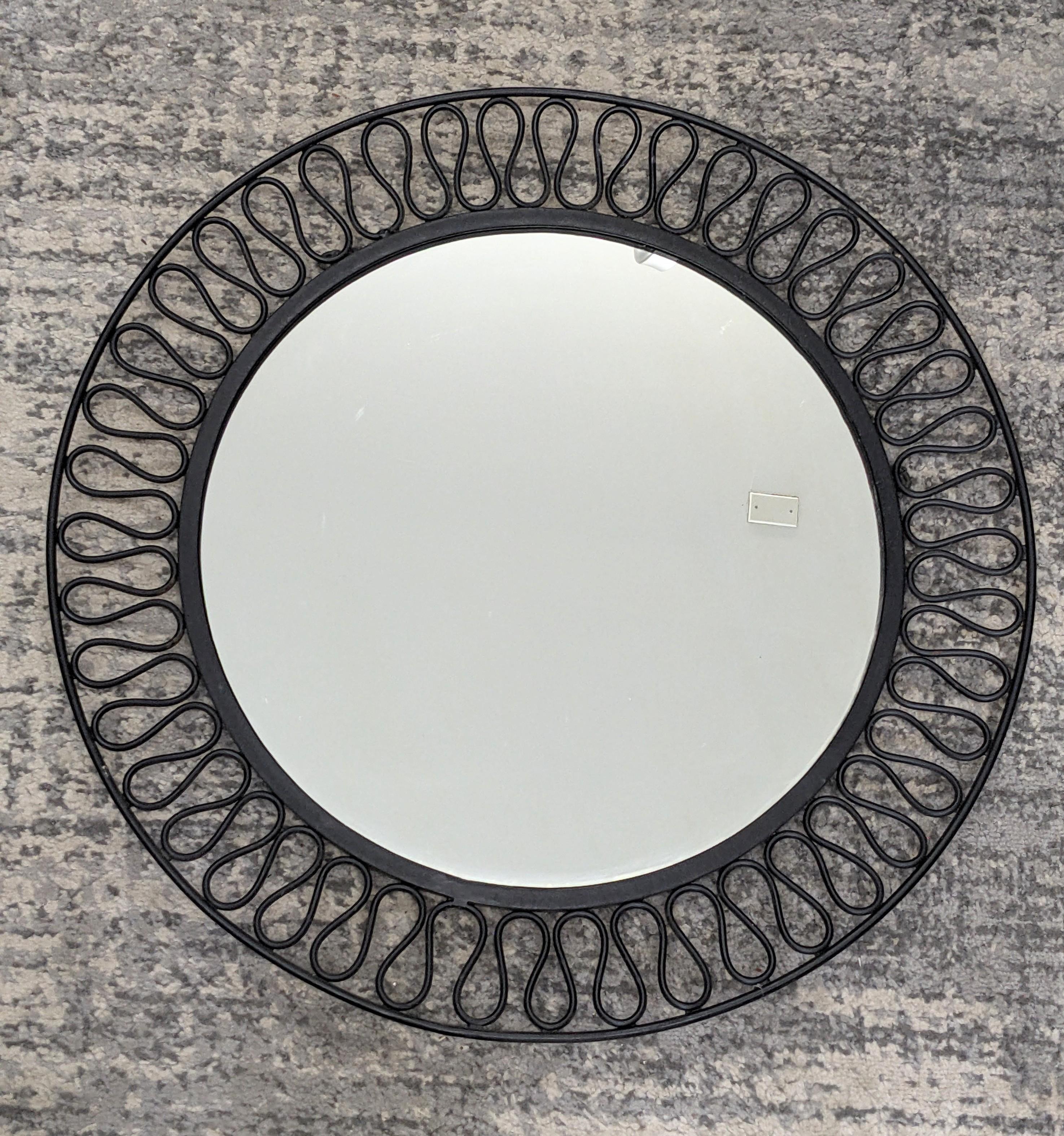 Striking Mid Century Iron Squiggle Mirror from the 1950's. Black enamel iron with French 40's squiggle motif border. 1950's USA. 
Width 24.5