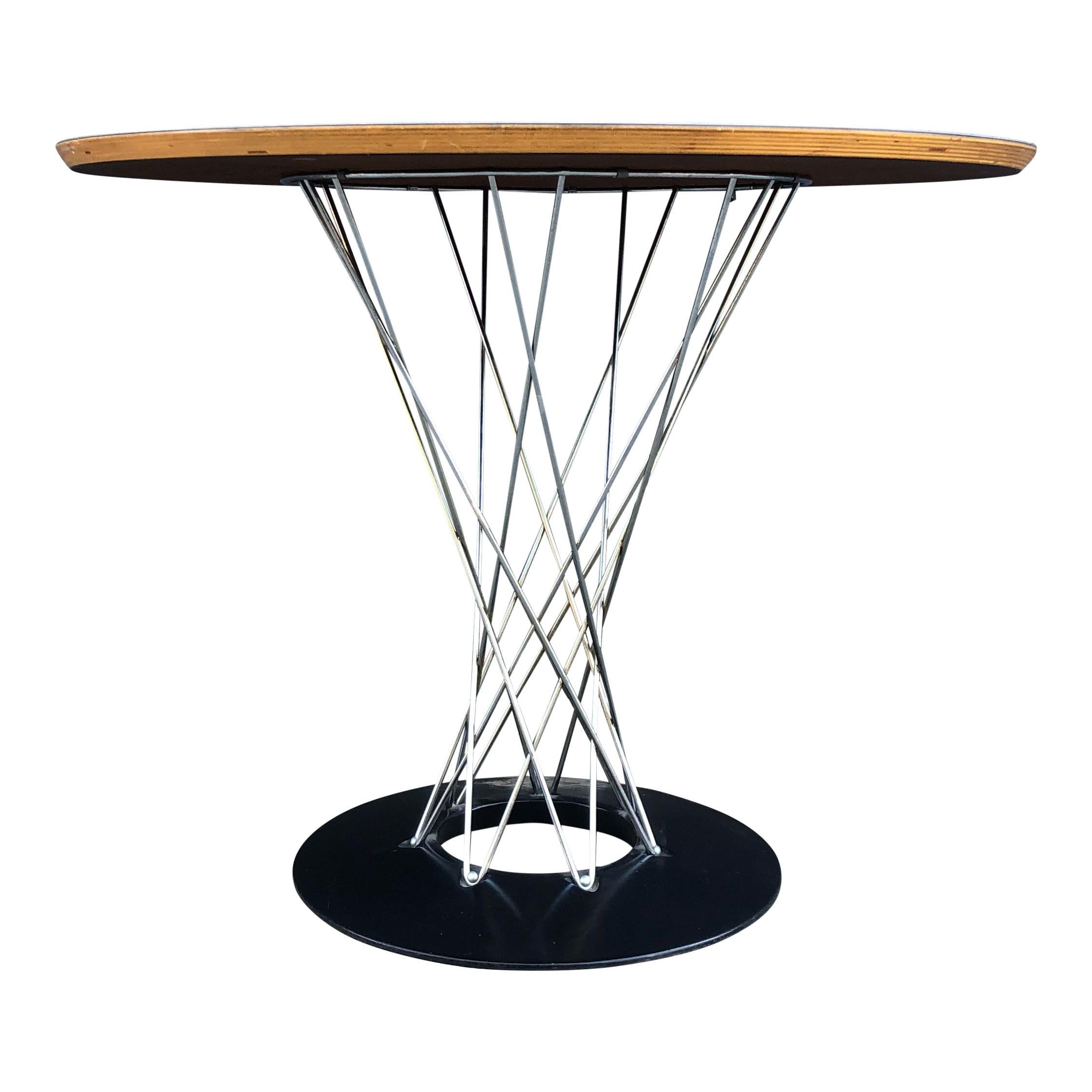 For sale is vintage Isamu Noguchi for Knoll cyclone table with a white laminate top.

This is a great piece of Mid-Century Modern design produced by Knoll in the 1950s and 1960s. It features a cast iron base coated in porcelain, twisting chrome