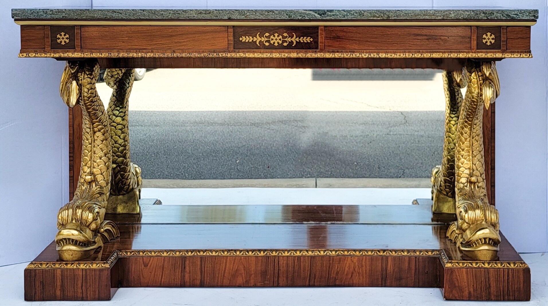 This is an amazing piece! It is an Italian neo-classical style mahogany , giltwood and marble top console table. The beautiful mahogany is banded with kingwood. The ebonized appointments are bordered with both brass and giltwood trims. The green
