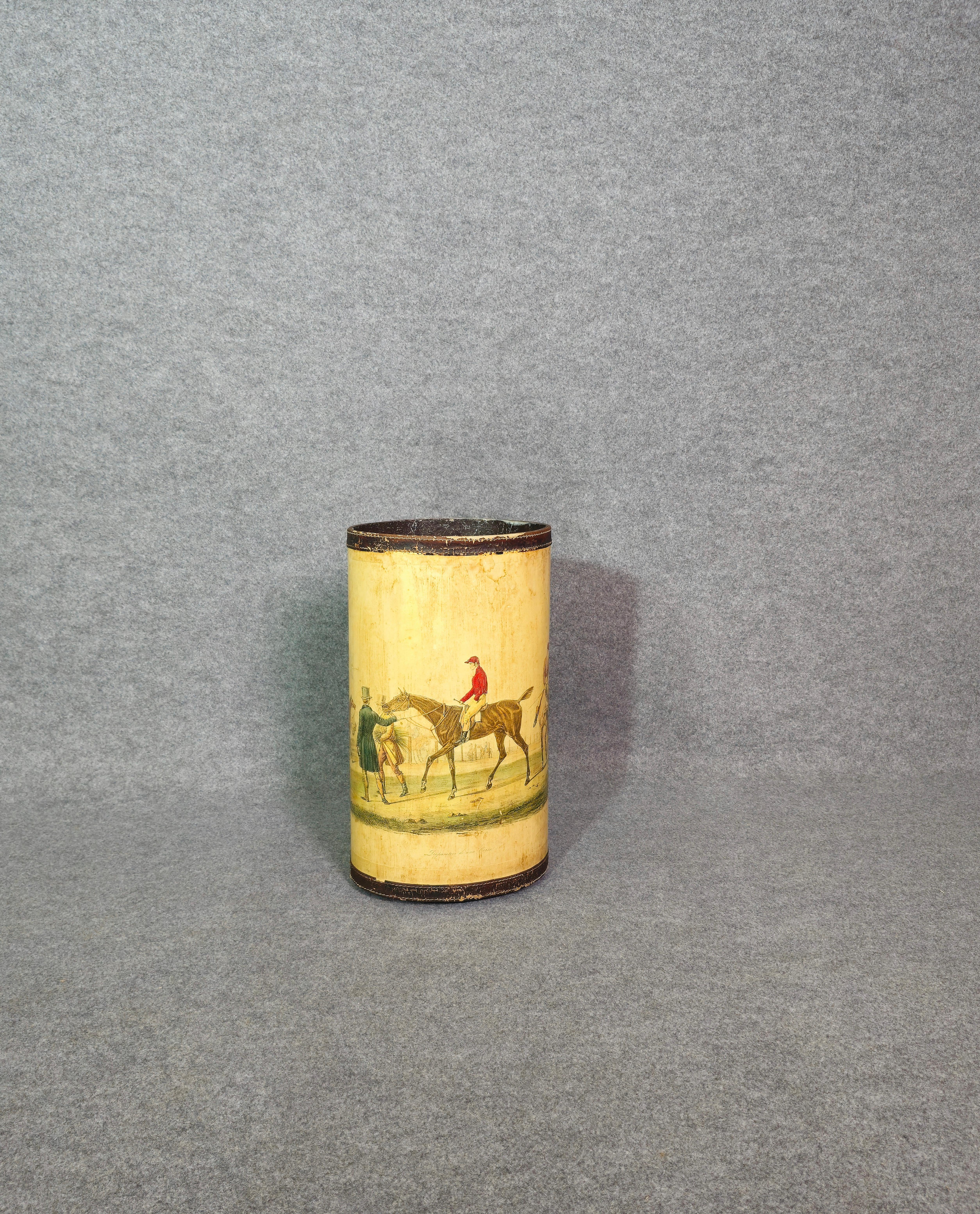 Umbrella stand or walking stick holder from the early 1950s. With leather embellishment and graphic prints depicting men on horseback in ivory. Oval in shape, it is made of metal, making the umbrella stand quite heavy and solid. Please watch the