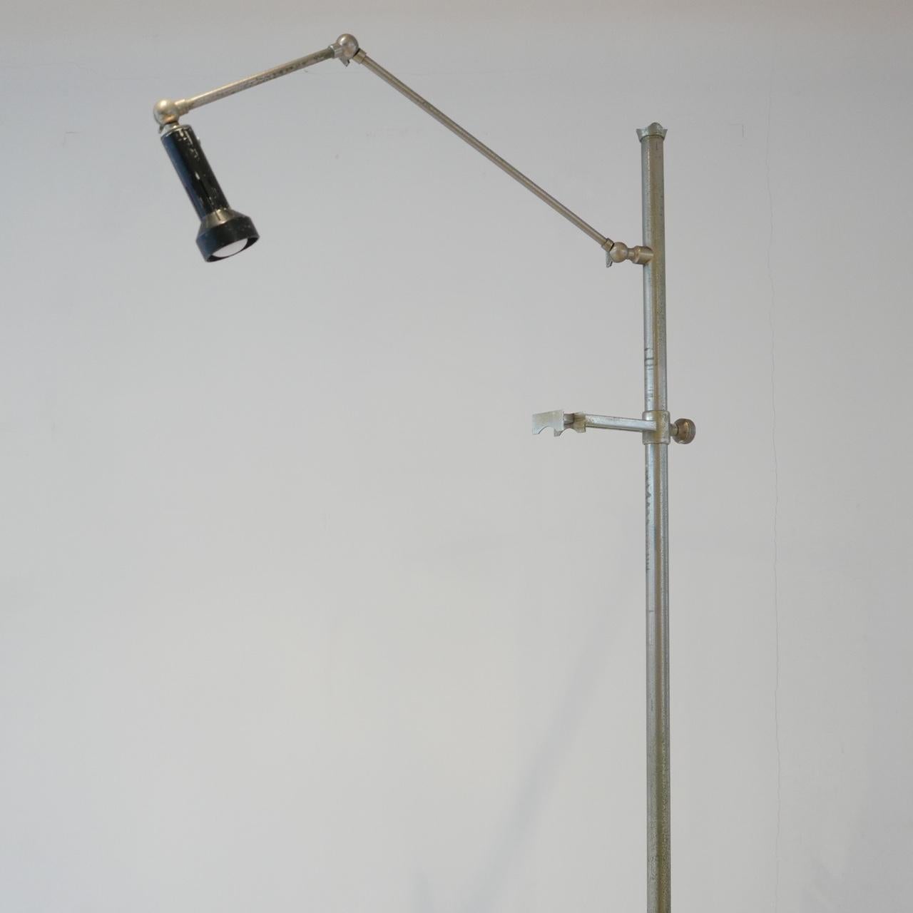 A rare easel floor lamp by Angelo Lelli for Arredoluce. 

Italian, circa 1960s.

Early version, chrome-plated brass. 

Pivoting enameled metal shade all in original condition.

We haven't polished it - it is retained in original condition