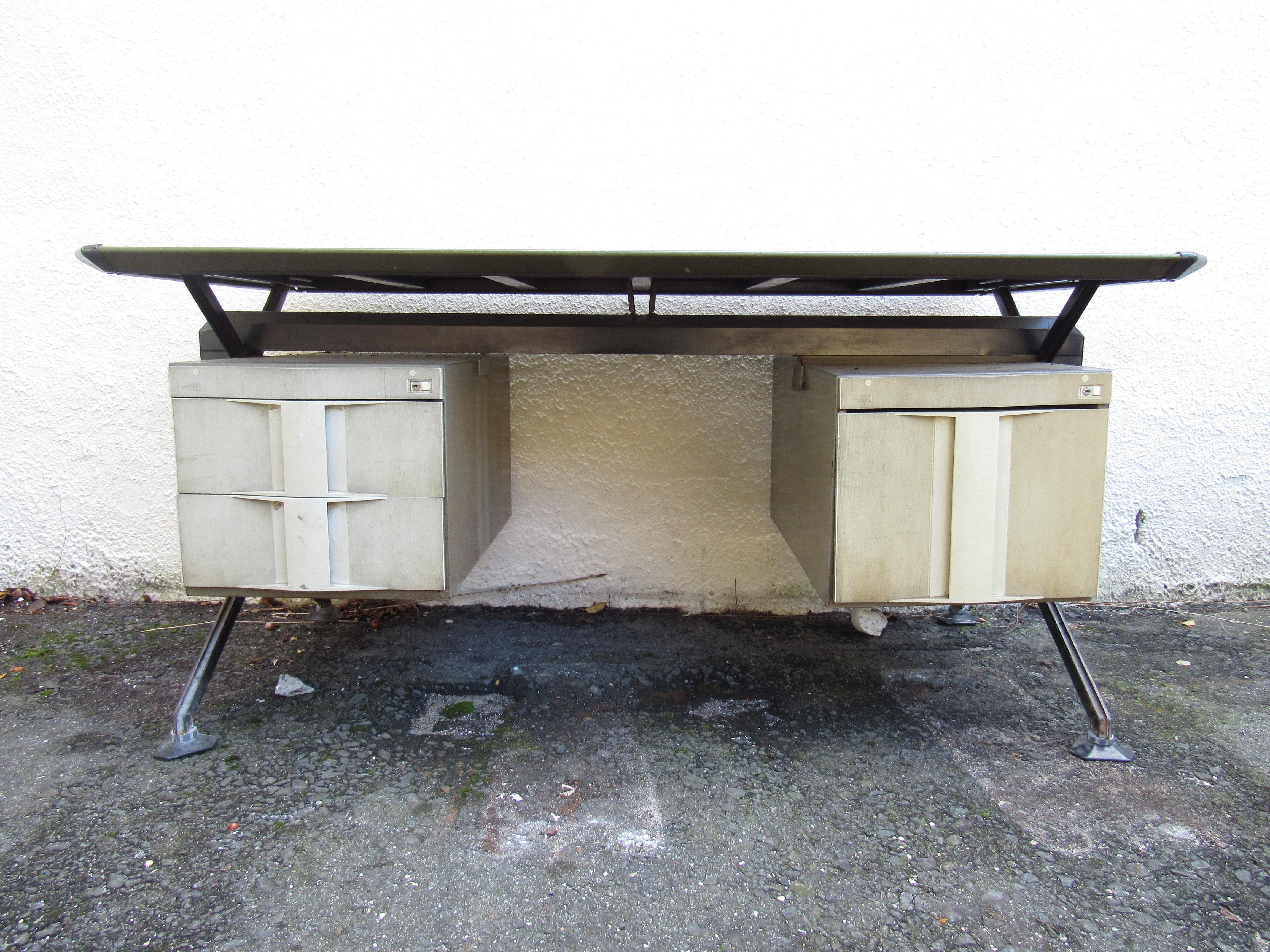 This impressive vintage modern desk boasts a floating top covered in faux textured leather. A stunning Italian Industrial Design that looks amazing in any setting. The metal frame has two hefty drawers on the right and a large filing drawer on the