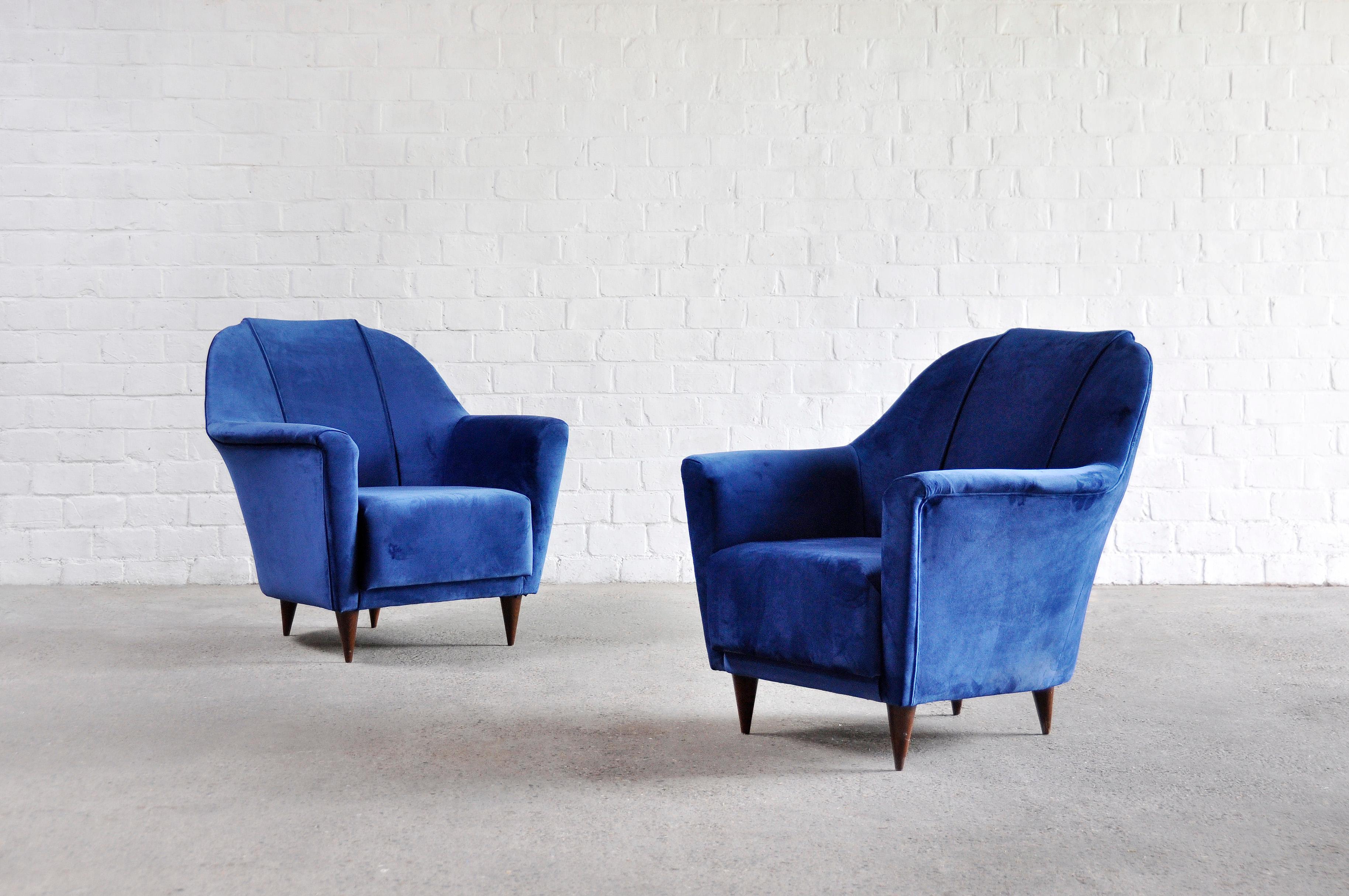 A pair of mid-century armchairs by Ico Parisi for Ariberto Colombo Cantu, designed in the 1950s. The pronounced curves and lines combined with the luxurious velvet fabric give these chairs a very chic and elegant feel. The seats feature a