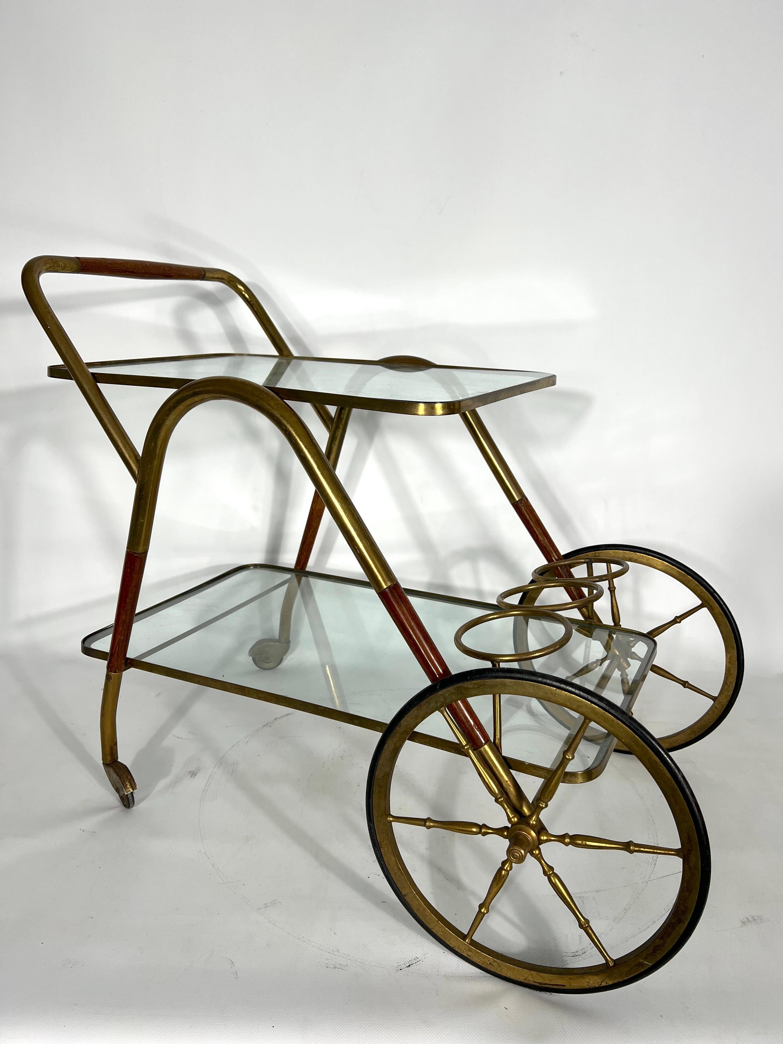 Good vintage condition with trace of age and use for this trolley or bar cart designed by Cesare Lacca and produced in Italy during the 50s. It is made from wood, brass and clear glass.