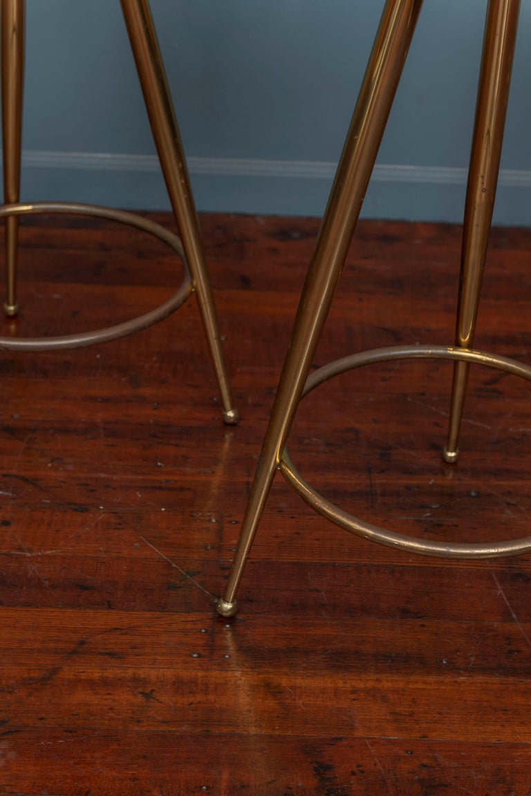 Mid-century Italian brass and leather barstools, made from tubular brass frames with newly upholstered white leather seats. Signs of age appropriate patina to the brass plating but ready to install and enjoy.