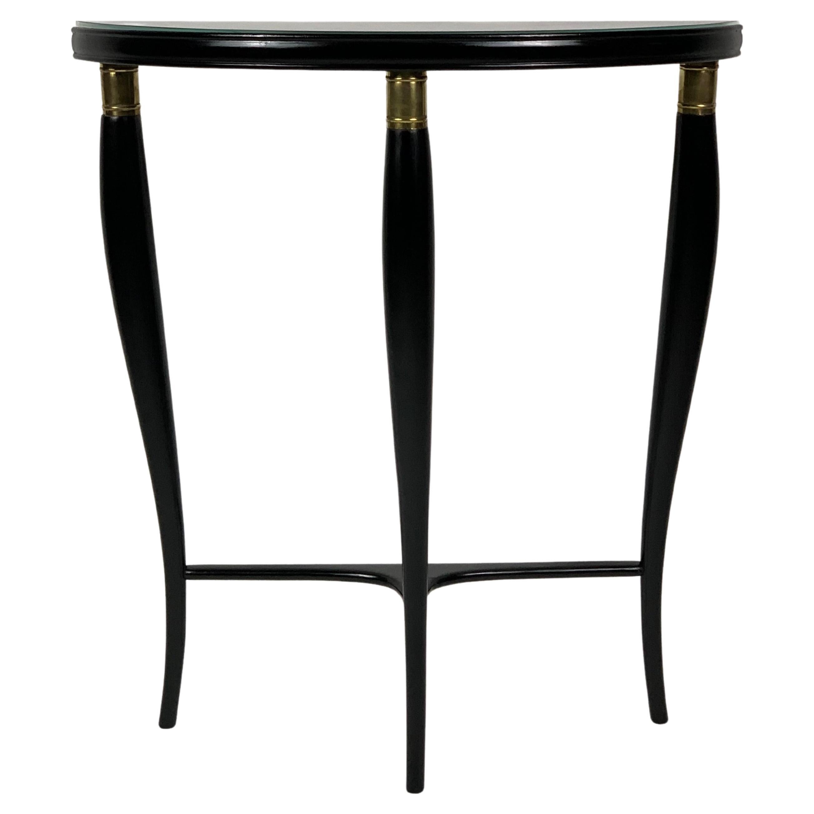 Mid Century Italian console table with three curved shaped legs that taper towards the bottom, connected by a horizontal element. The apex of these three legs are finished and enriched by a sort of cylindrical brass collar.
The three legs support a