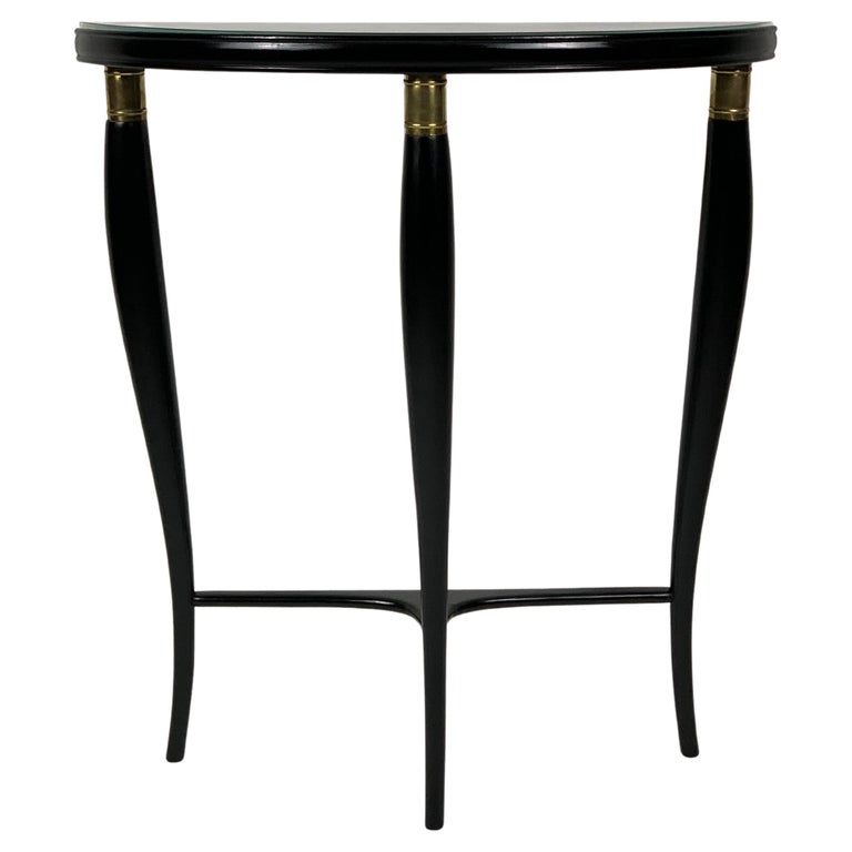 Mid Century Italian console table with three curved shaped legs that taper towards the bottom, connected by a horizontal element. The apex of these three legs are finished and enriched by a sort of cylindrical brass collar.
The three legs support a