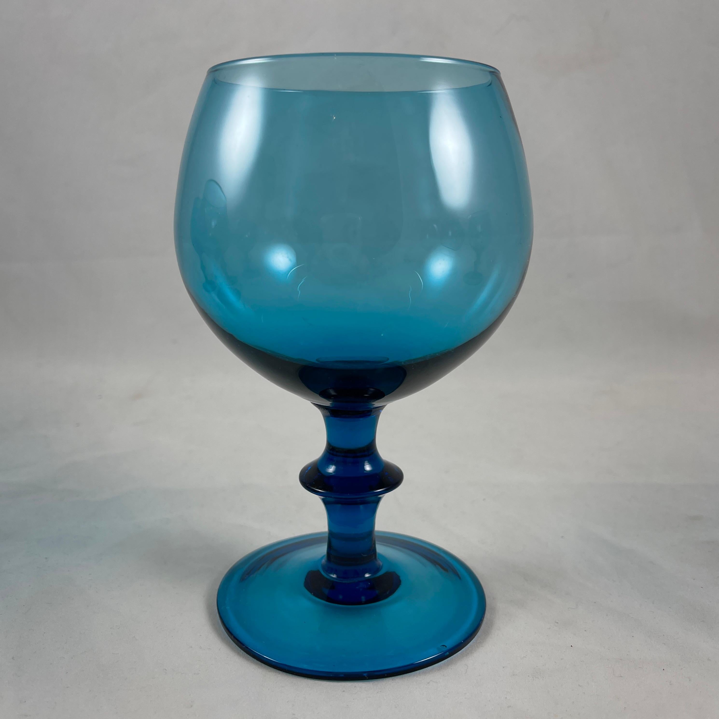 From the Empoli region of Northern Italy, a set of eight teal blue glass goblets, circa 1960-1970.

Hand blown, a balloon form upper on a tall footed shaped stem. A larger goblet of fine quality in a great saturated color.

Measures: 6 in. H x 4