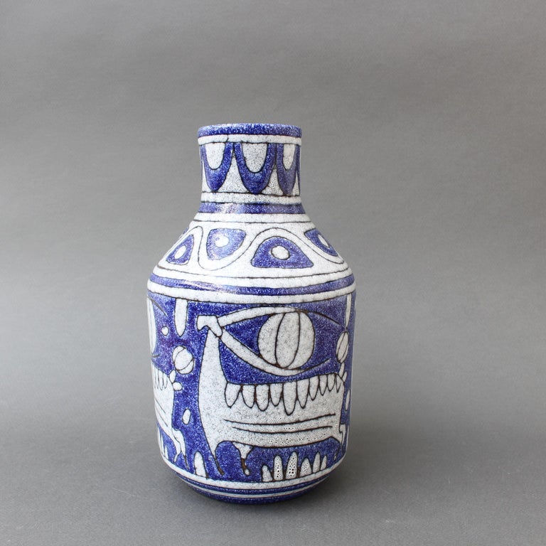 Mid-century Italian ceramic decorative vase by Fratelli Fanciullacci (circa 1960s). Rich blue, geometric shapes, primeval animals suggestive of cave drawings and an elegant form combine for this stunning decorative vase. It will certainly transport