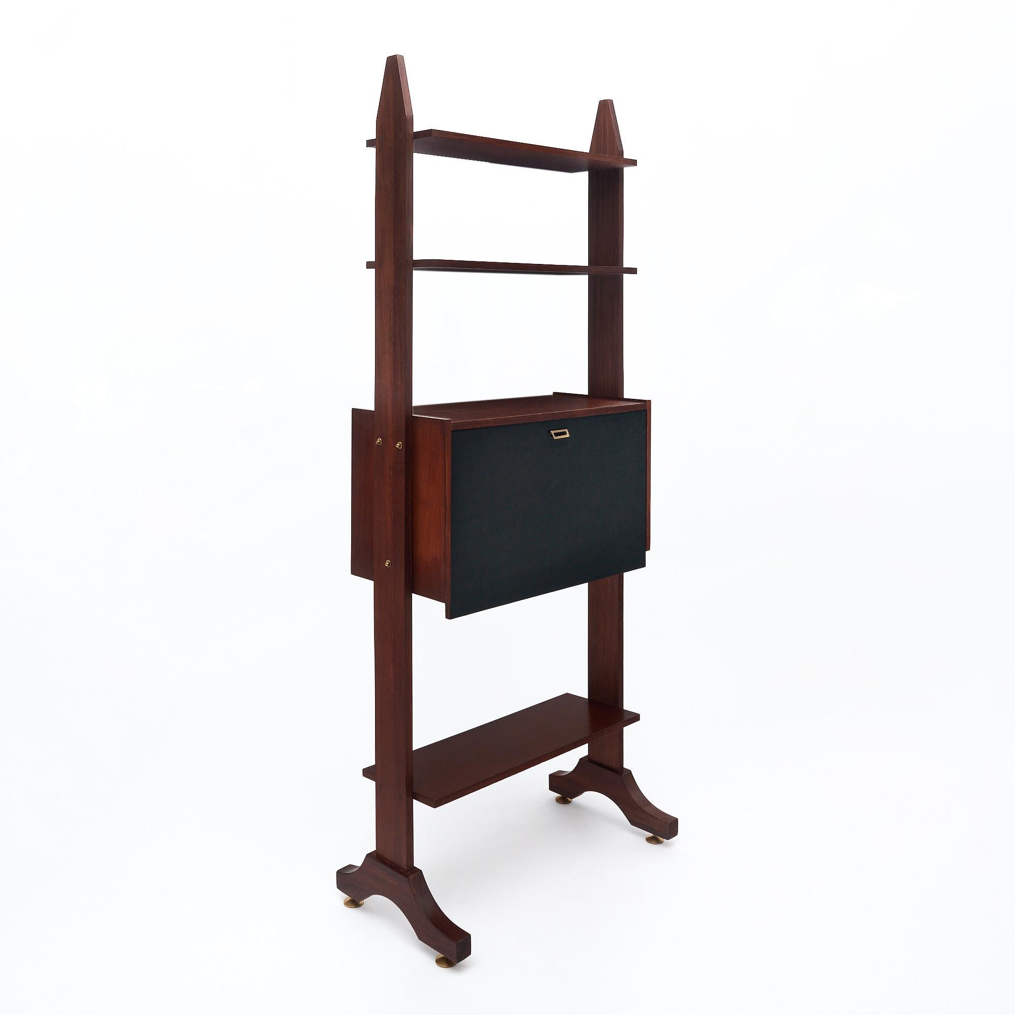 Libreria di metà secolo in Italia. Questo pezzo è realizzato in legno di mogano con un design verticale. Ci sono diversi ripiani per la funzionalità e una credenza con il frontale ebanizzato. L'armadio si apre con una chiave e una serratura in