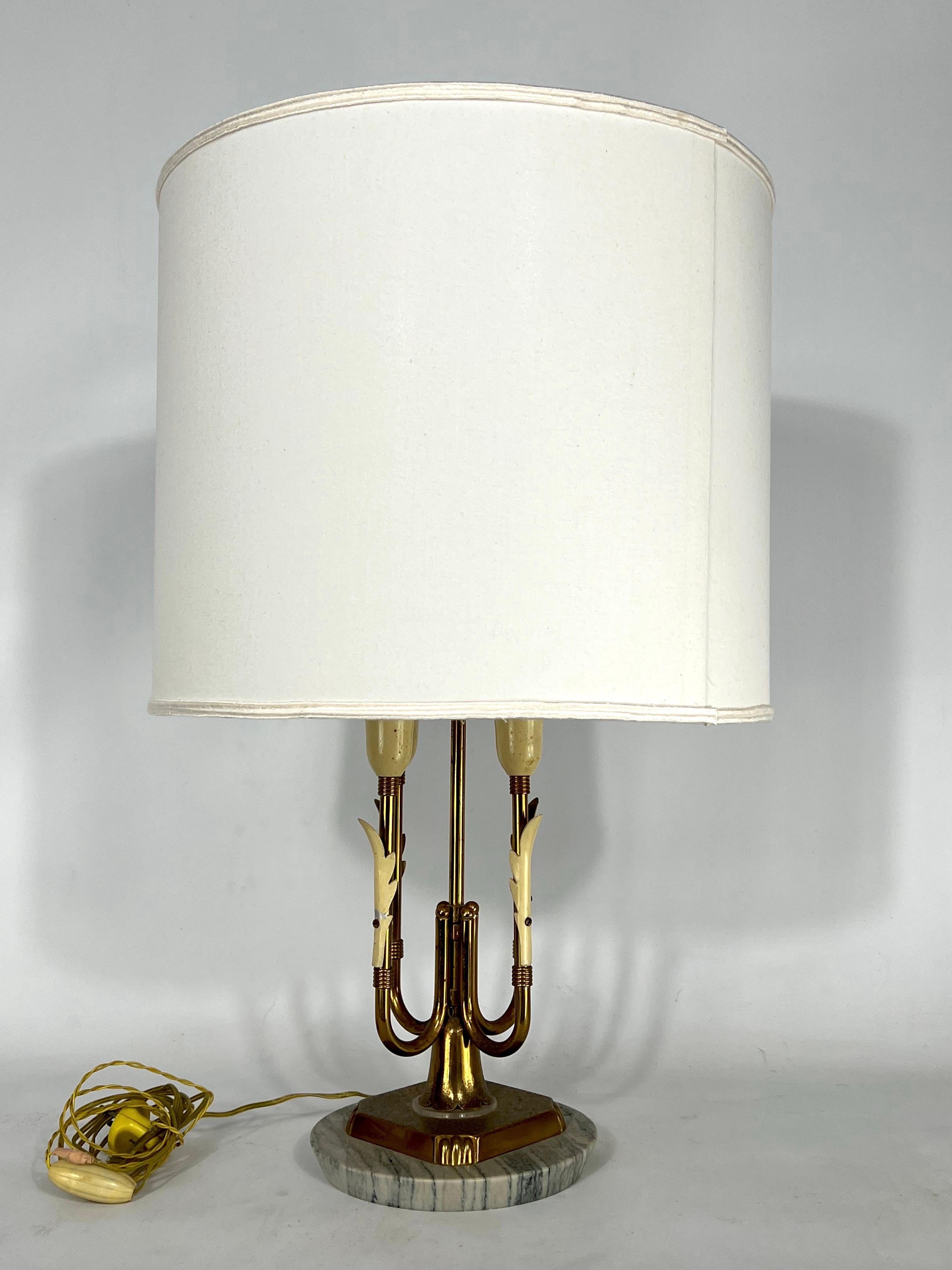 Good vintage condition with trace of age and use and spots on the brass for this brass and marble table lamp produced in Italy during the 50s. It mounts four sockets for E14 lamps. Full working with EU standard, adaptable on demand for USA standard.