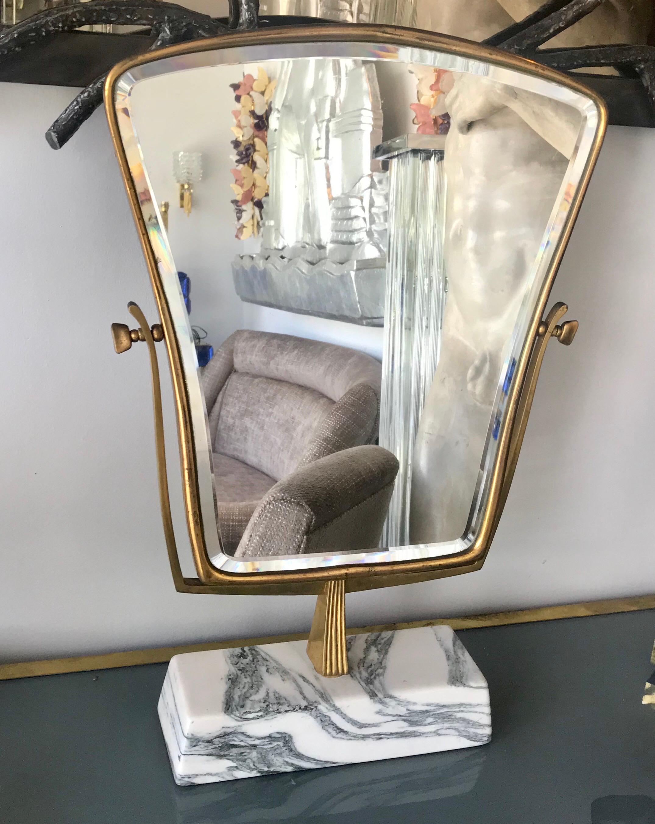 Beautiful Gio Ponti Italian table/vanity mirror of brass with white Carrara marble base, circa 1960s
The mirror is beveled and the overall condition is very good.